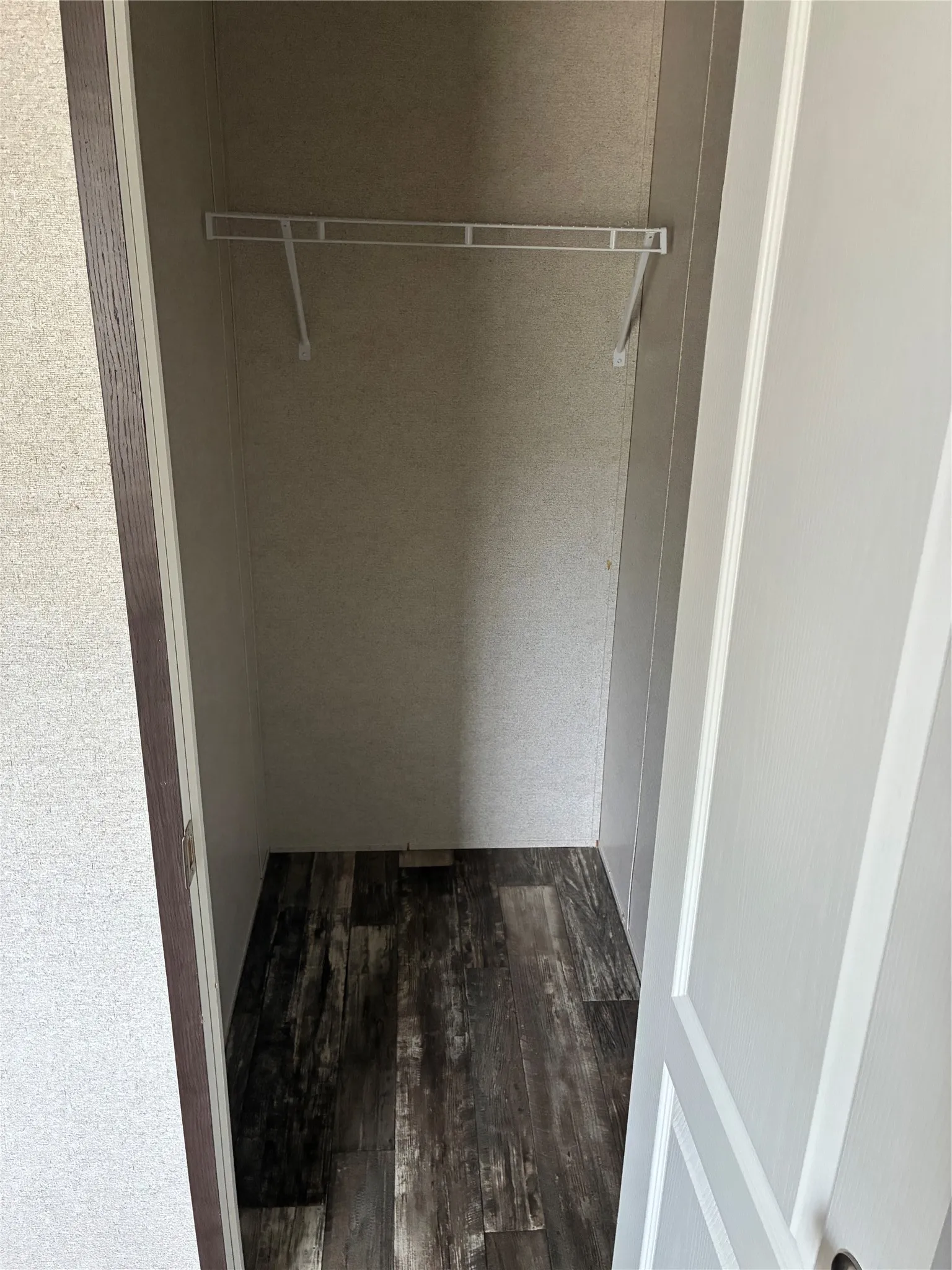 Closet featuring wood-finish flooring and a wire shelving system