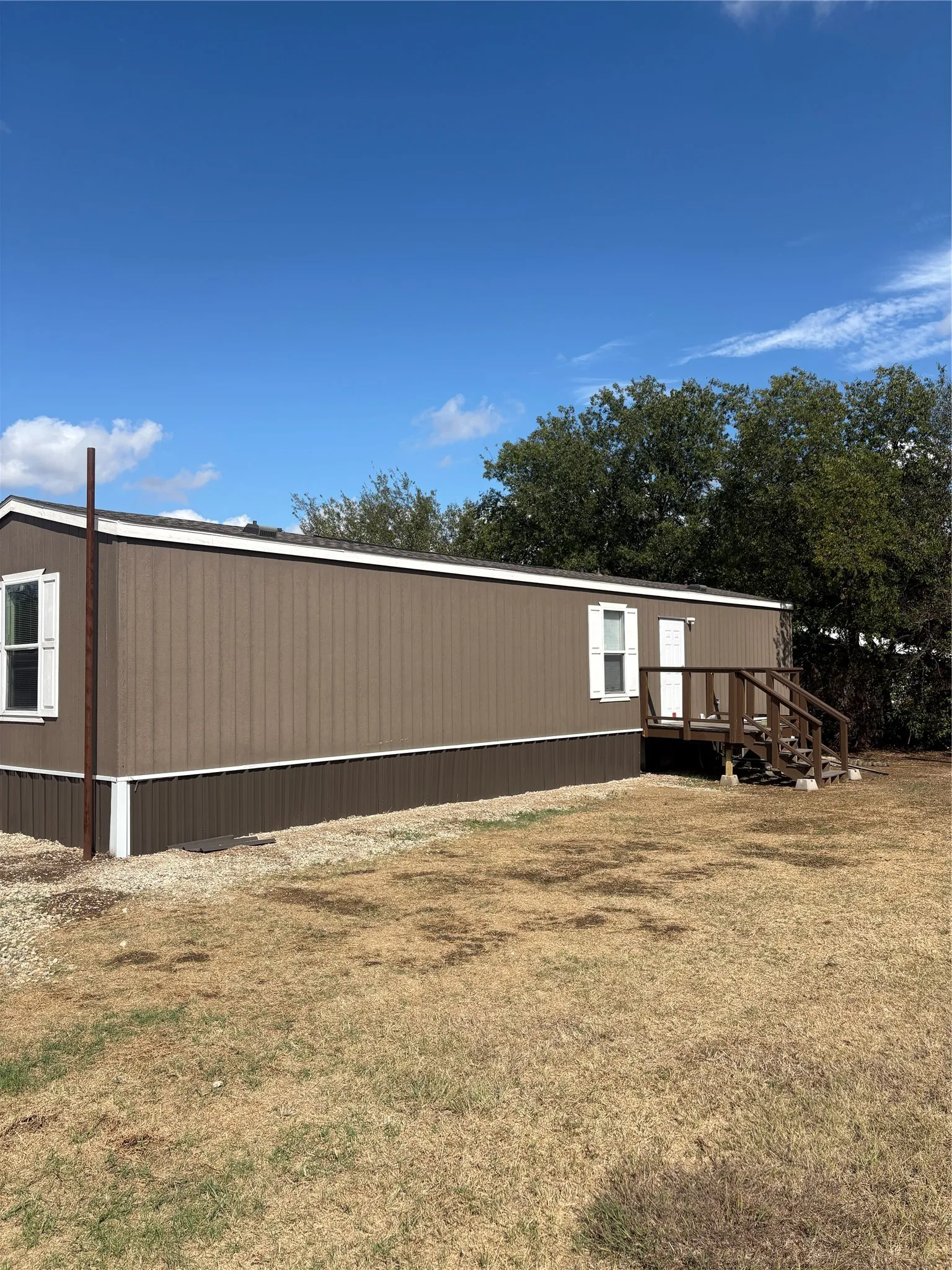 Brown exterior siding with white trim