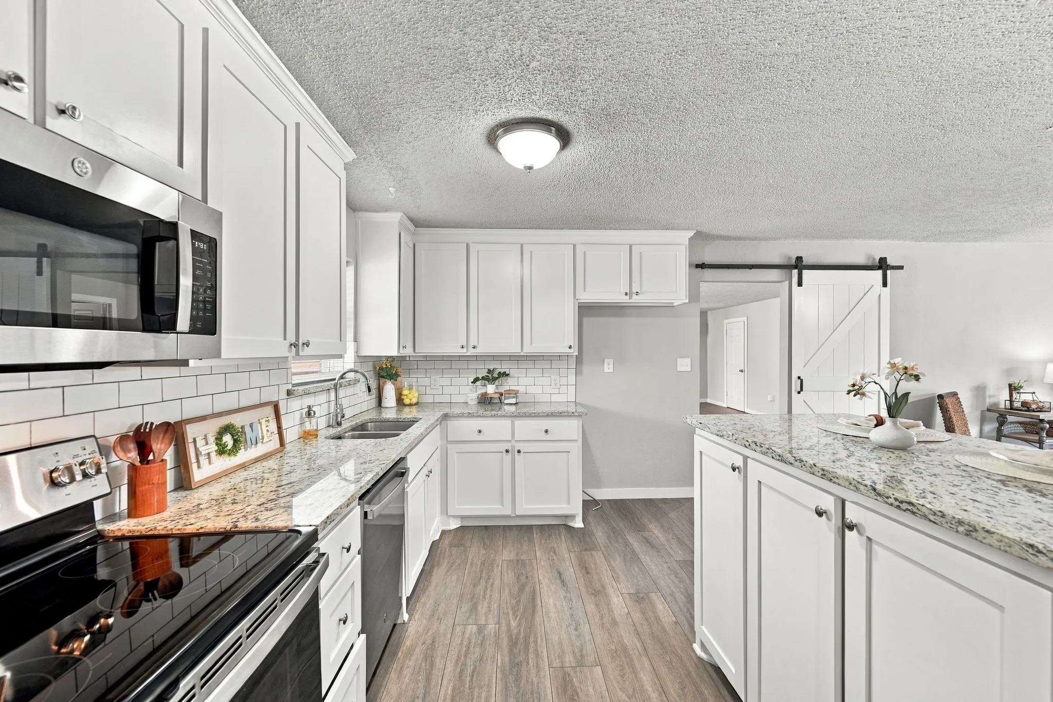 Gorgeous BRIGHT kitchen with pantry, granite, SS appliances, and plenty of storage.