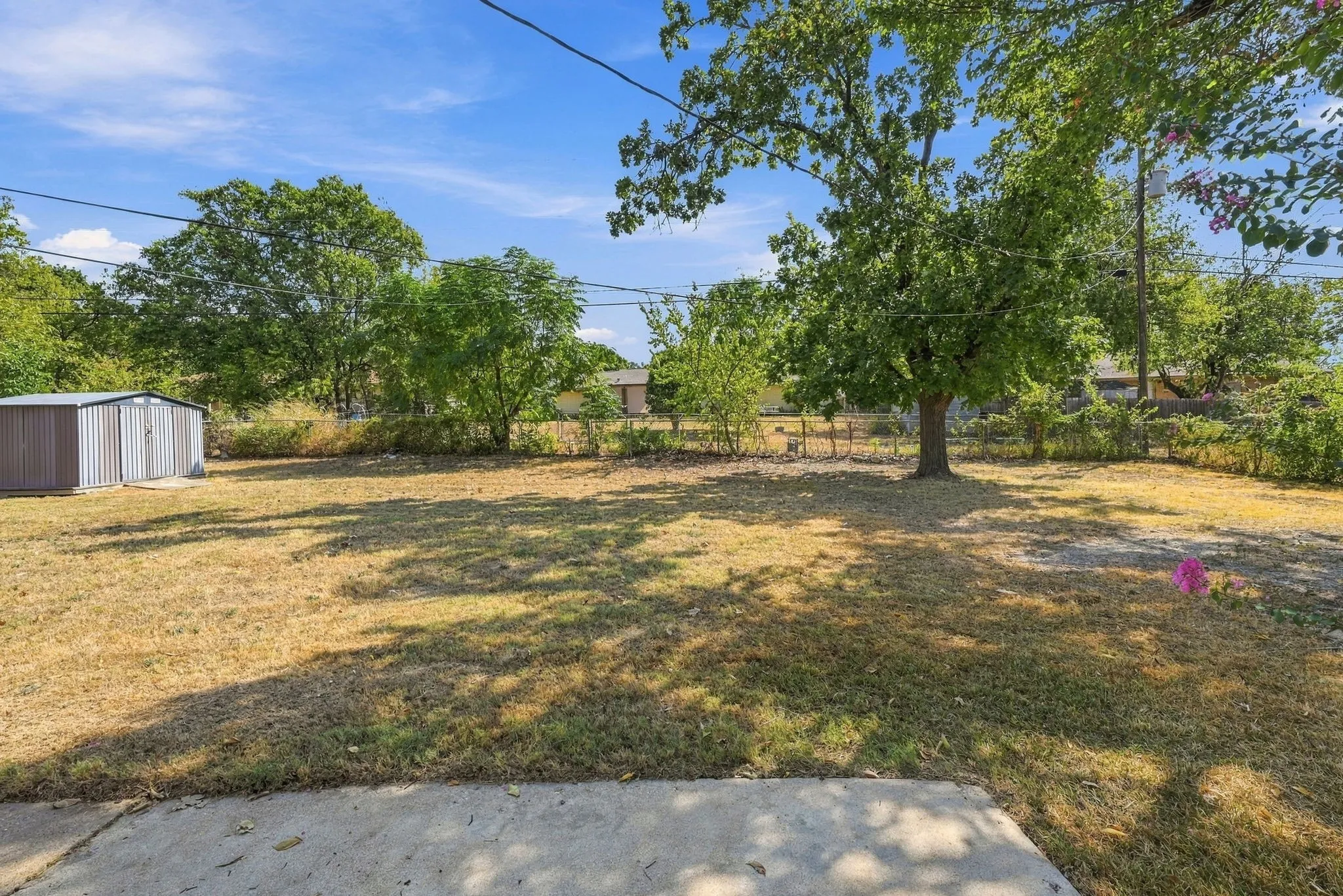 HUGE fenced in backyard with patio, mature trees and shed