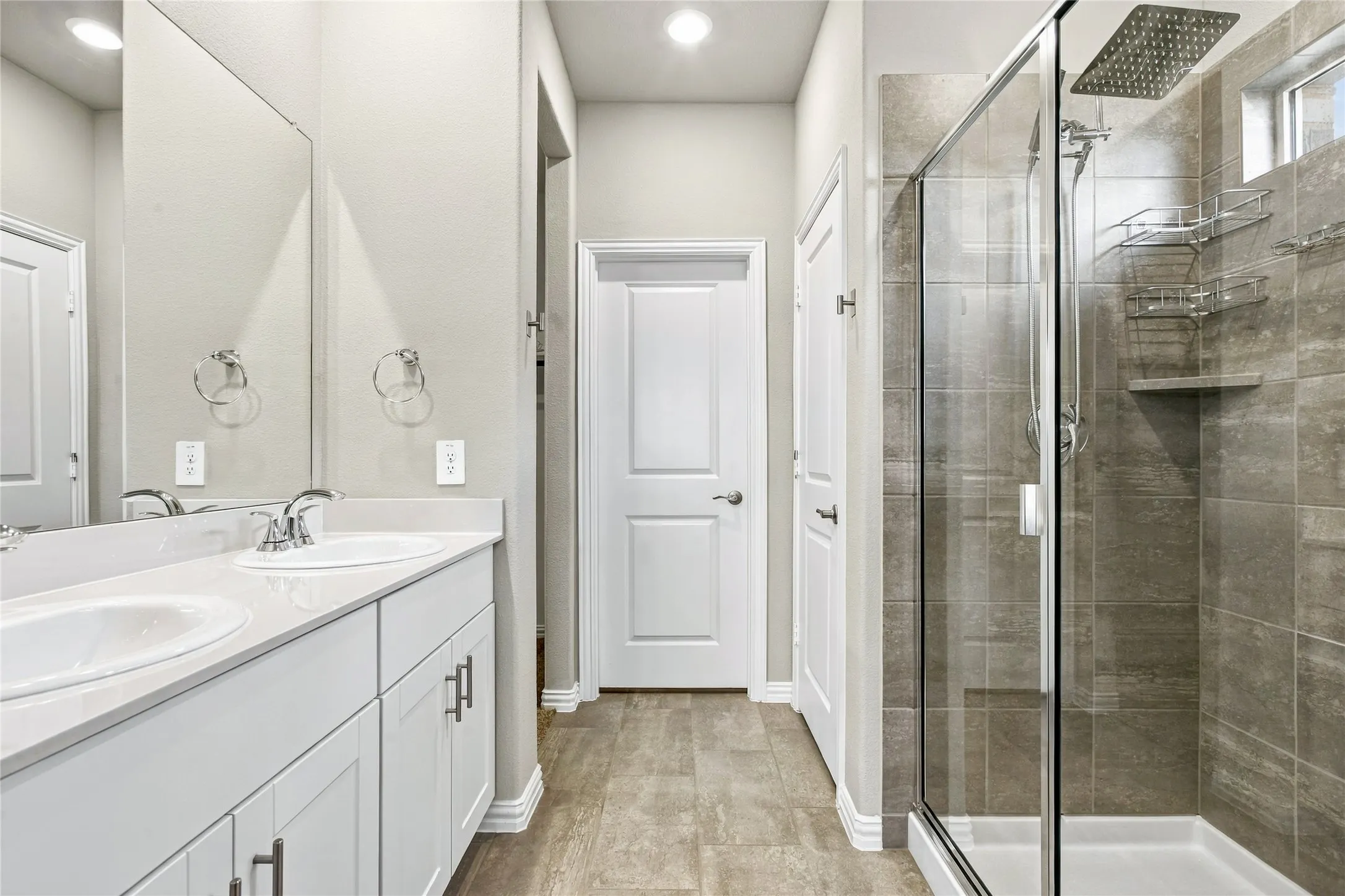 Dual vanity with white cabinetry, quartz-finish countertop, and chrome fixtures