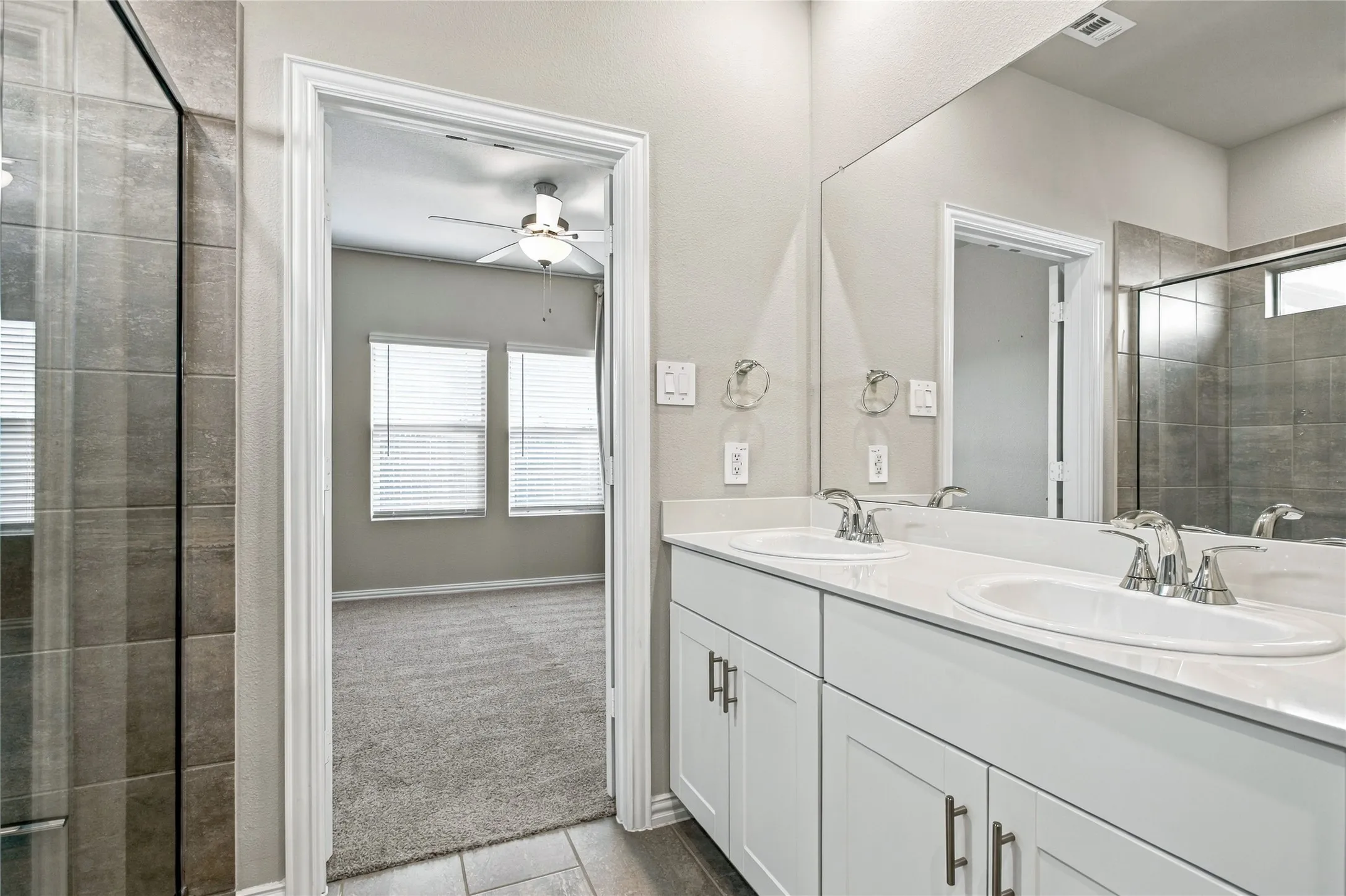 Dual vanity with undermount sinks, white cabinetry, and brushed nickel hardware