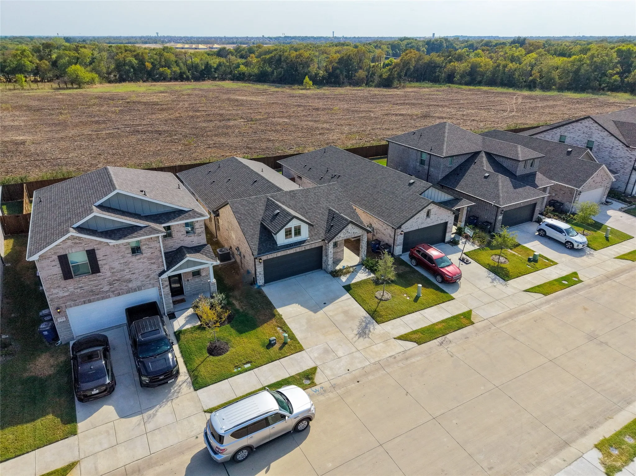 Brick exterior with dark shingle roofing