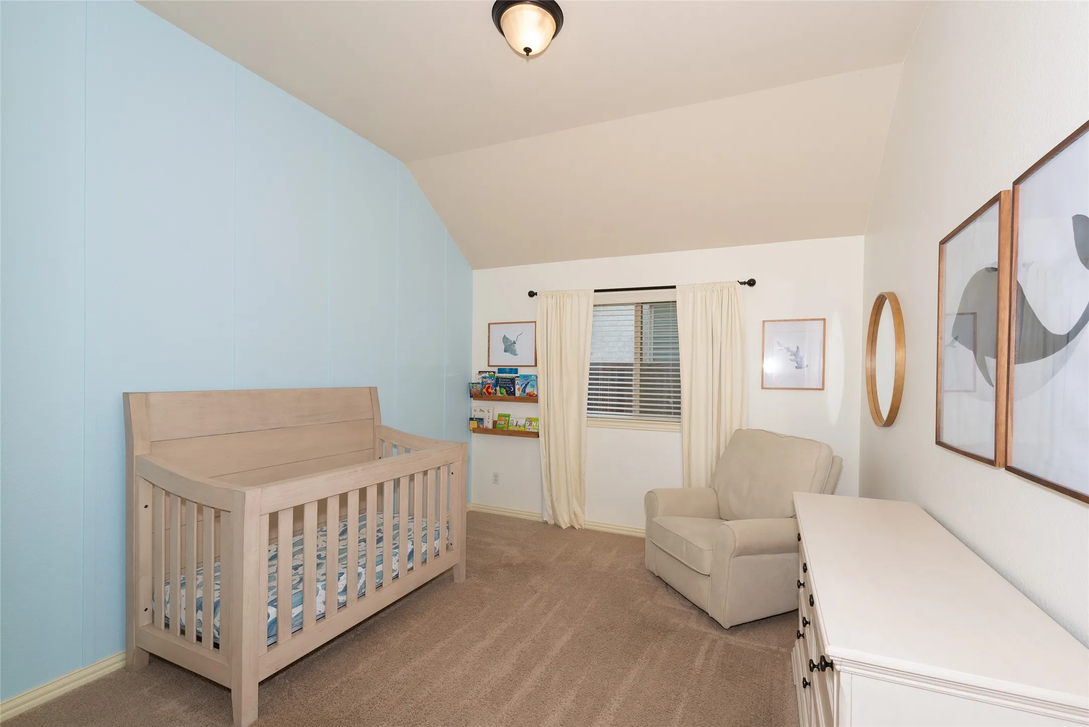 Sloped ceiling, recessed window, carpeted flooring, built-in shelving, and overhead lighting