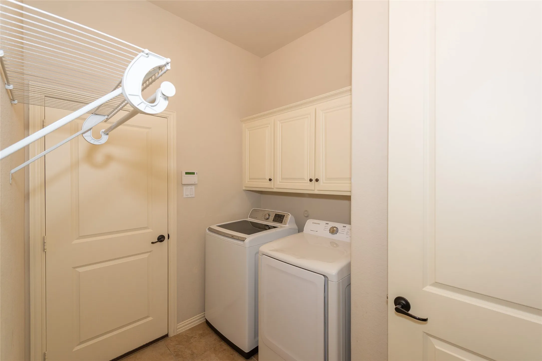 Built-in white cabinetry, light-toned walls, and a light-toned flooring