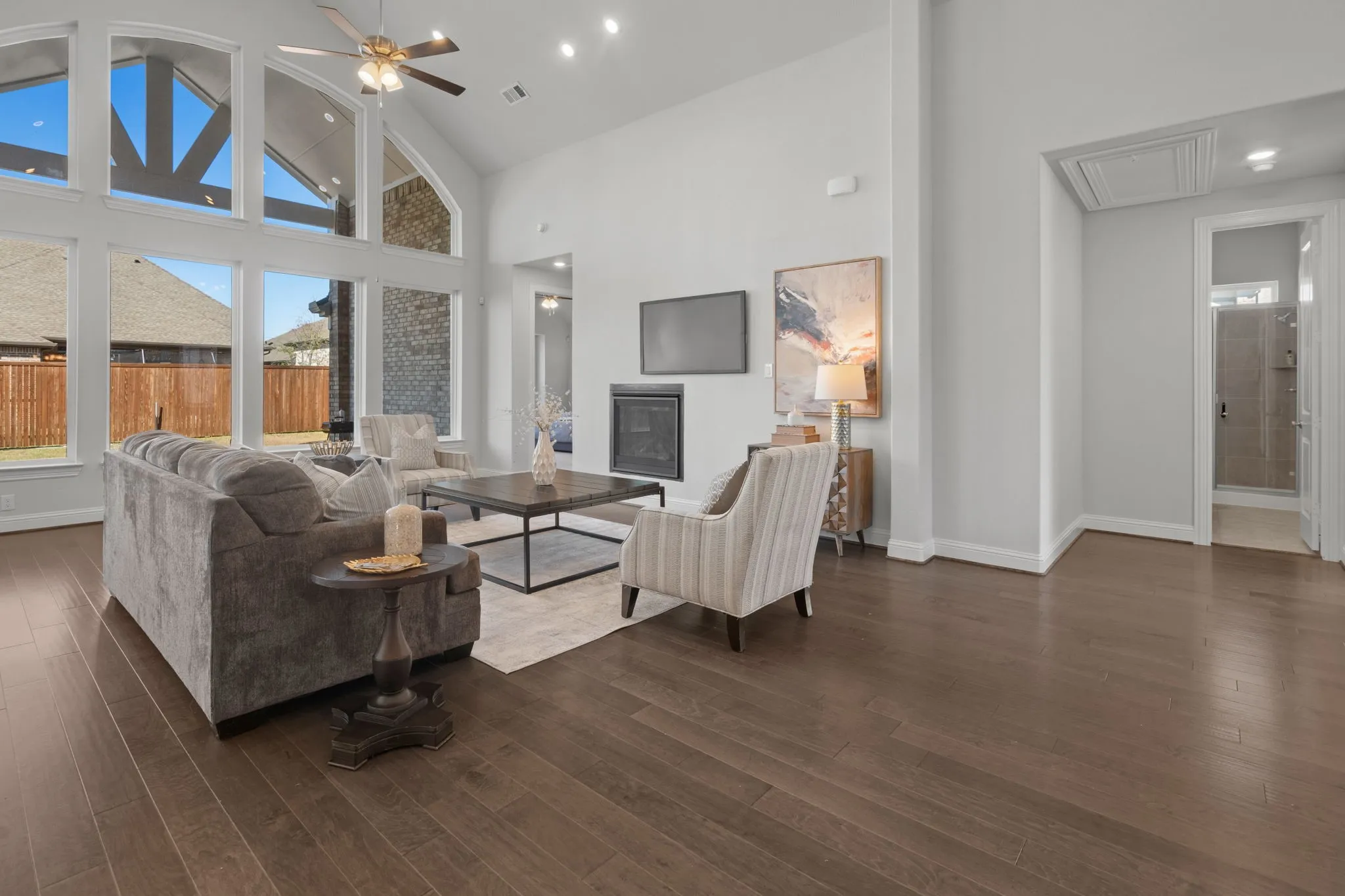Vaulted Cathedral Style ceiling, Luxury vinyl wood-finish flooring, built-in fireplace, and recessed lighting