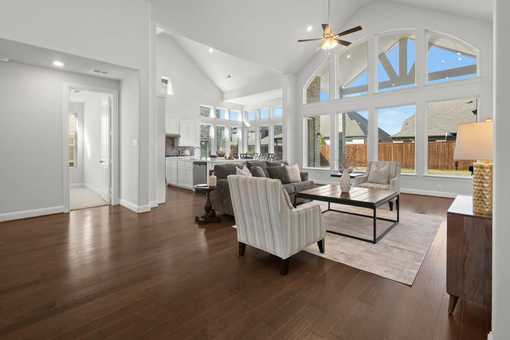 Vaulted Cathedral Style ceiling, Luxury vinyl wood-finish flooring, piucture window, and recessed lighting