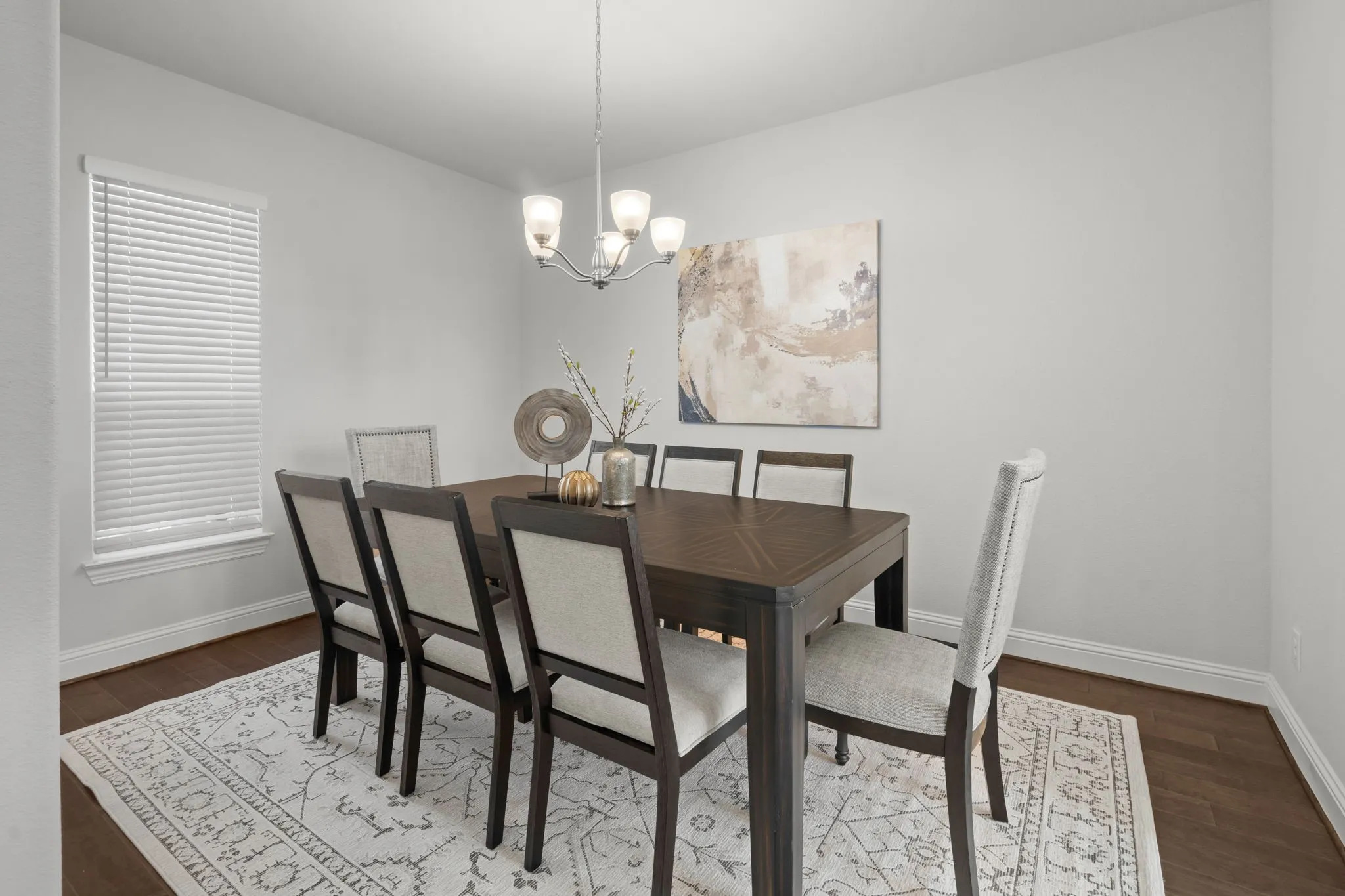 Warm wood-finish flooring with a decorative area rug