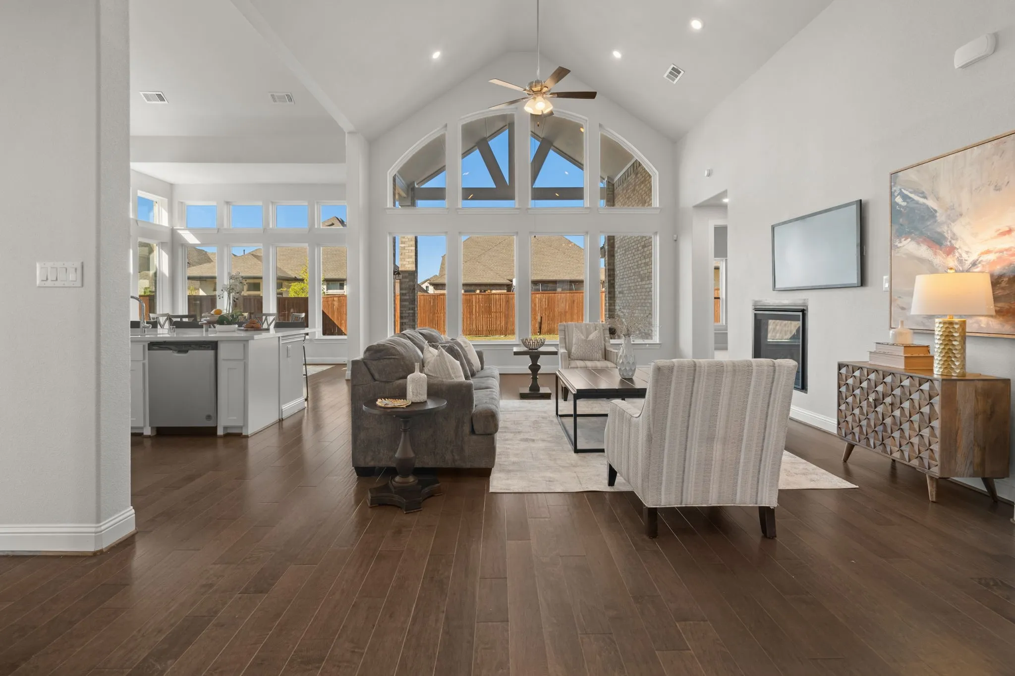Vaulted Cathedral Style ceiling, Luxury vinyl wood-finish flooring, built-in fireplace, view of kitchen - quartz island and recessed lighting