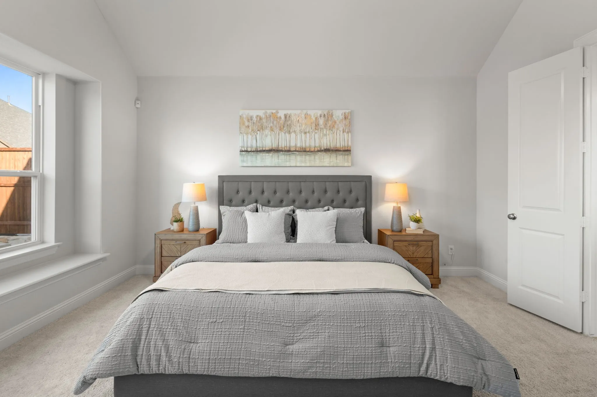 Light-filled room featuring a single window, neutral wall paint, and carpet flooring
