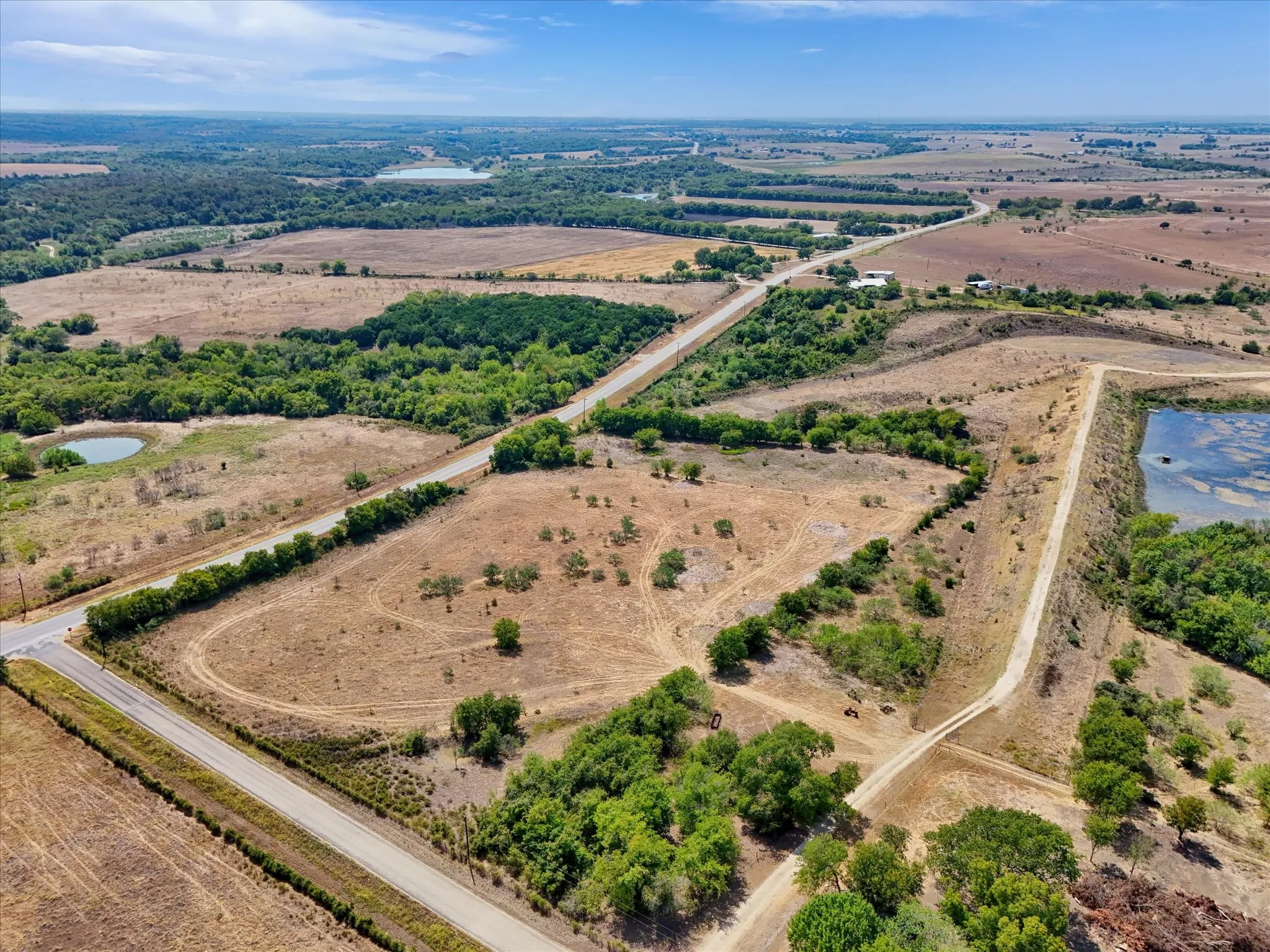 Expansive acreage featuring natural landscape, multiple ponds, and accessible roadways