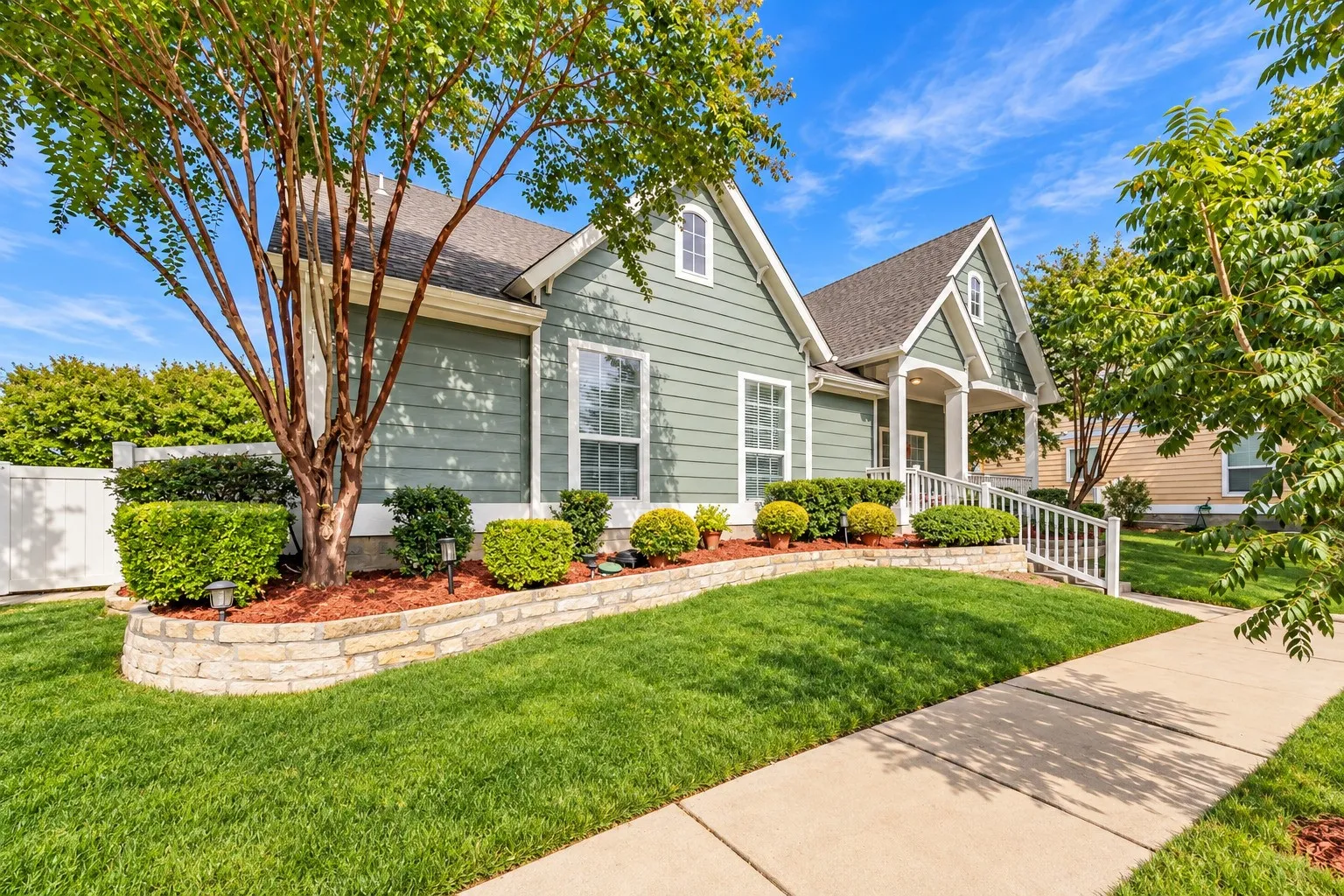 Siding exterior with multiple gables and a covered porch