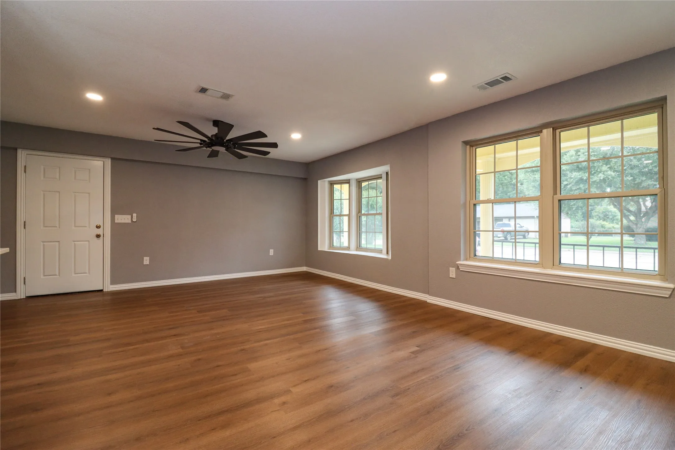 Wood-finish flooring, recessed lighting, and a modern ceiling fan