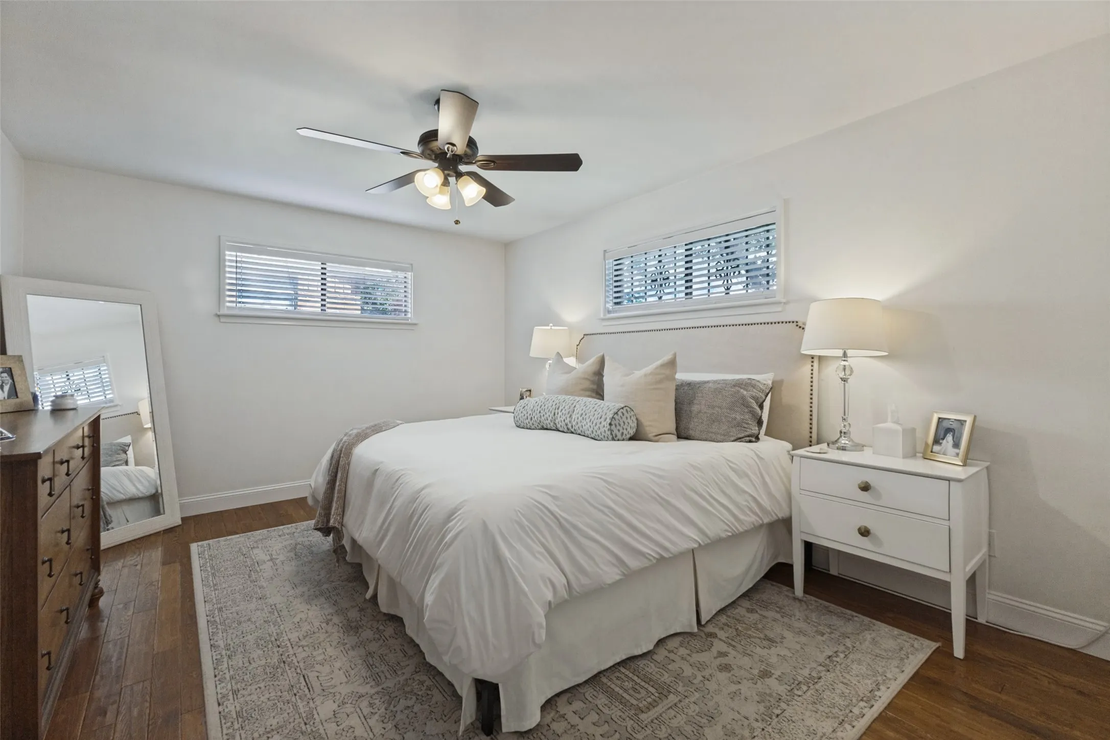 Wood-finish flooring with white walls and trim