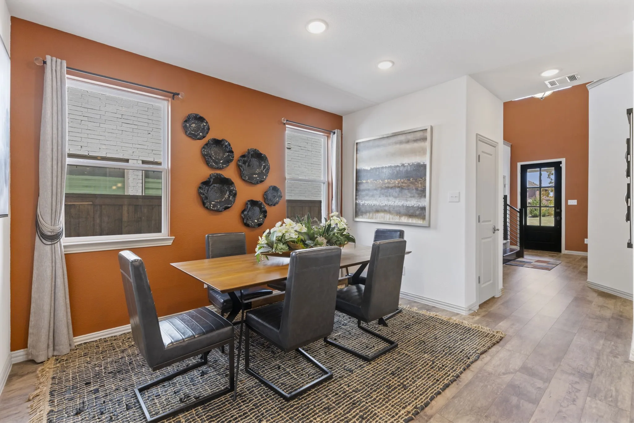 Wood-finish flooring throughout, recessed lighting, and a solid core entry door