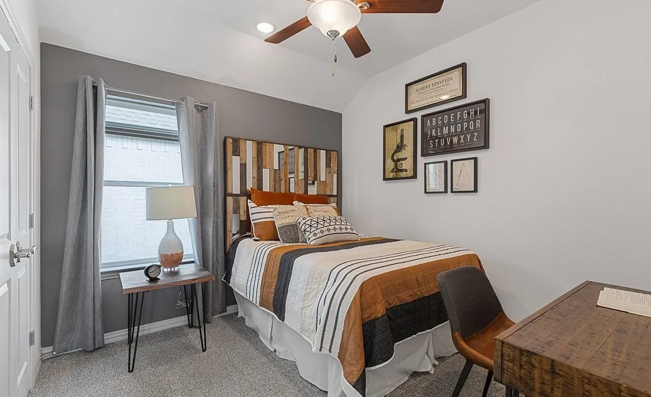 Angled vaulted ceiling with a ceiling fan, recessed lighting, and a window with blinds