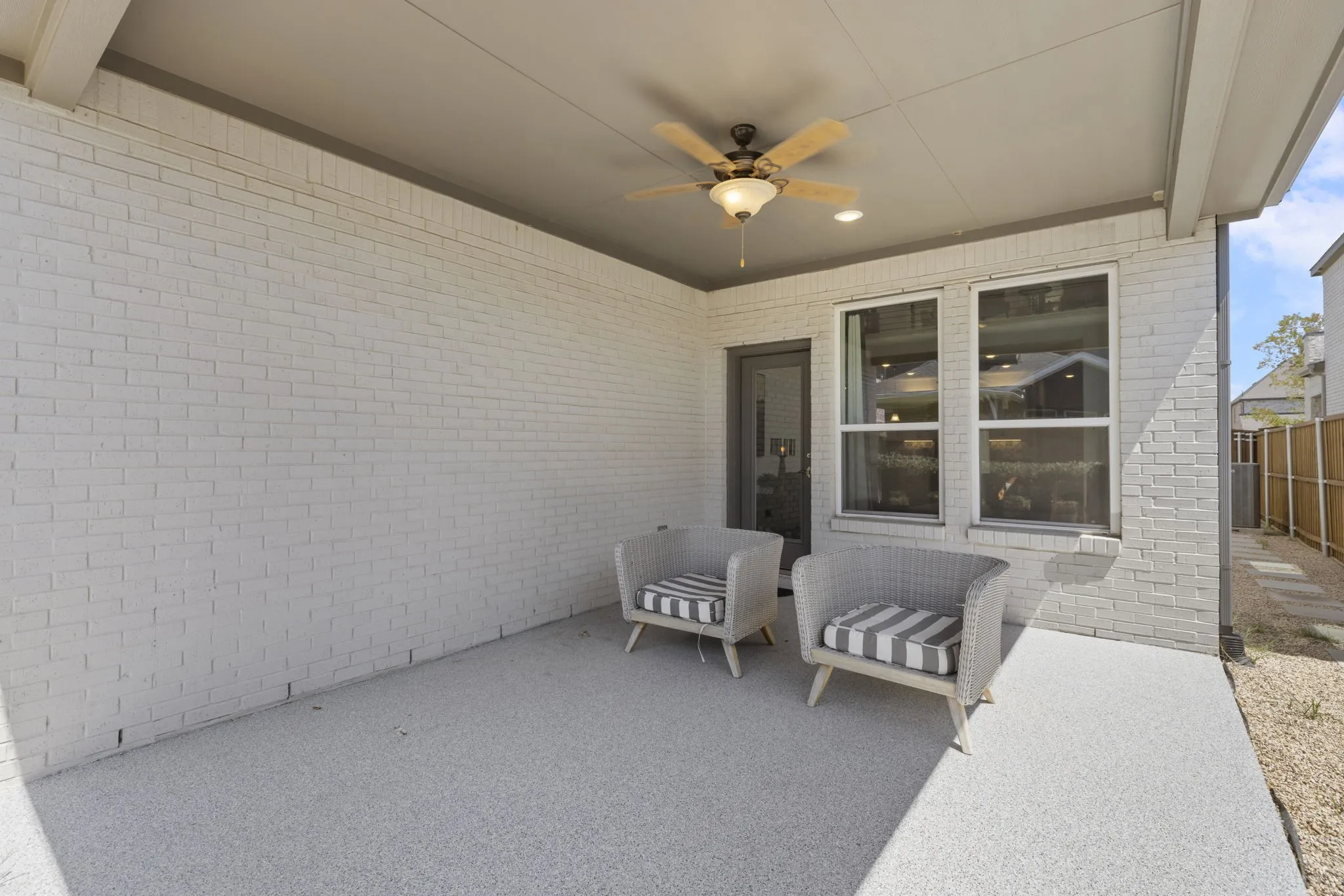 Covered patio with a ceiling fan, recessed lighting, and brick exterior