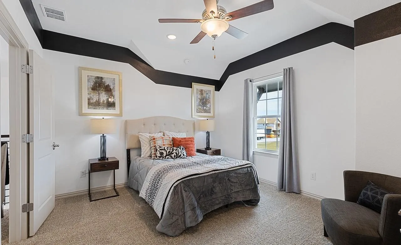 Tray ceiling with recessed lighting and a ceiling fan, window with white framing, and neutral carpeting