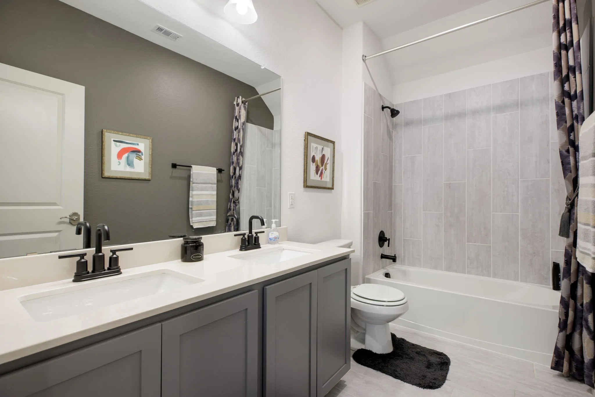 Dual vanity with integrated sinks, light-toned countertop, and dark-finish faucets