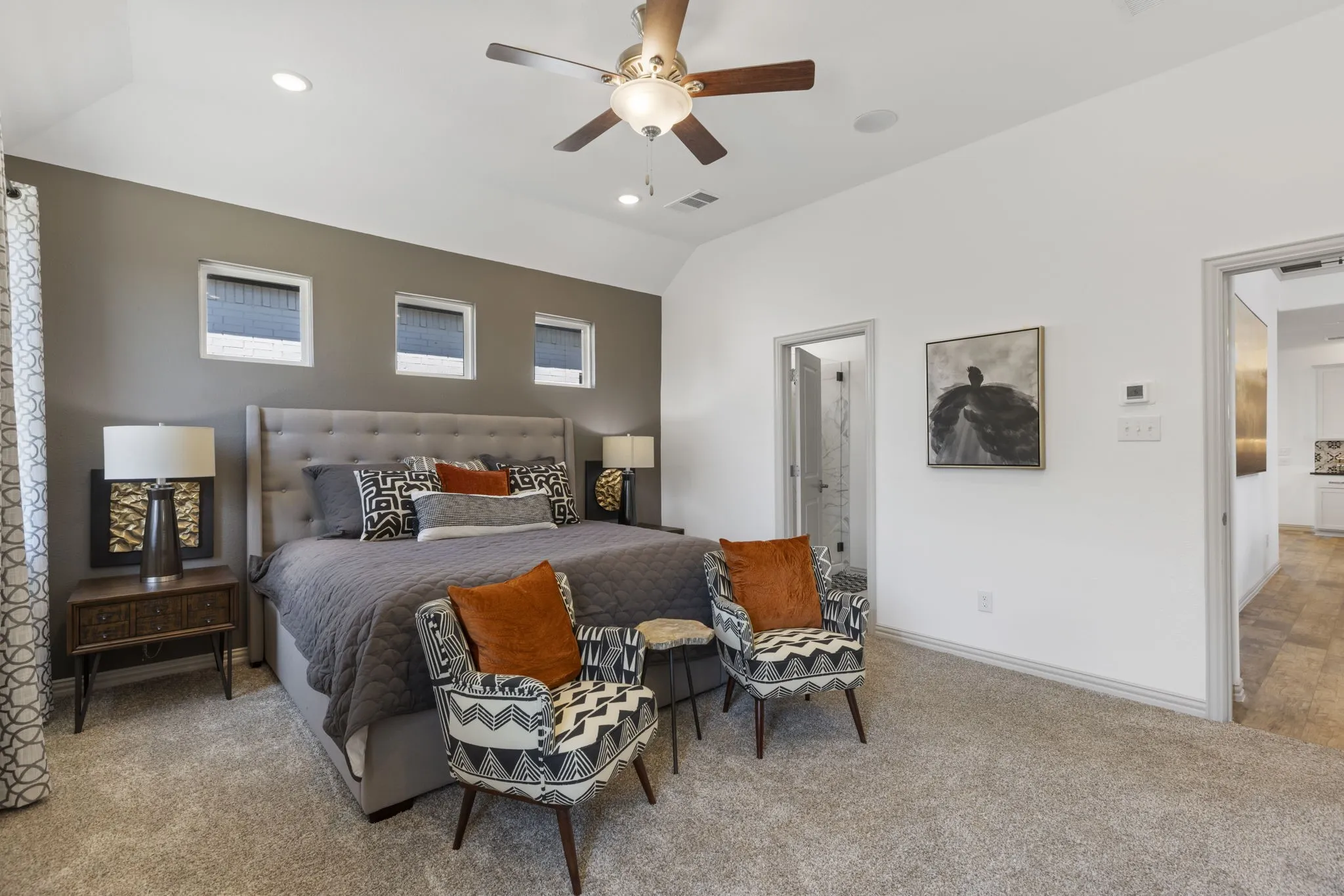 Carpeted bedroom featuring a vaulted ceiling with a ceiling fan and recessed lighting