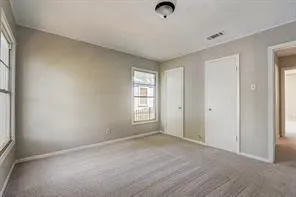 Neutral-toned walls complement plush carpeting