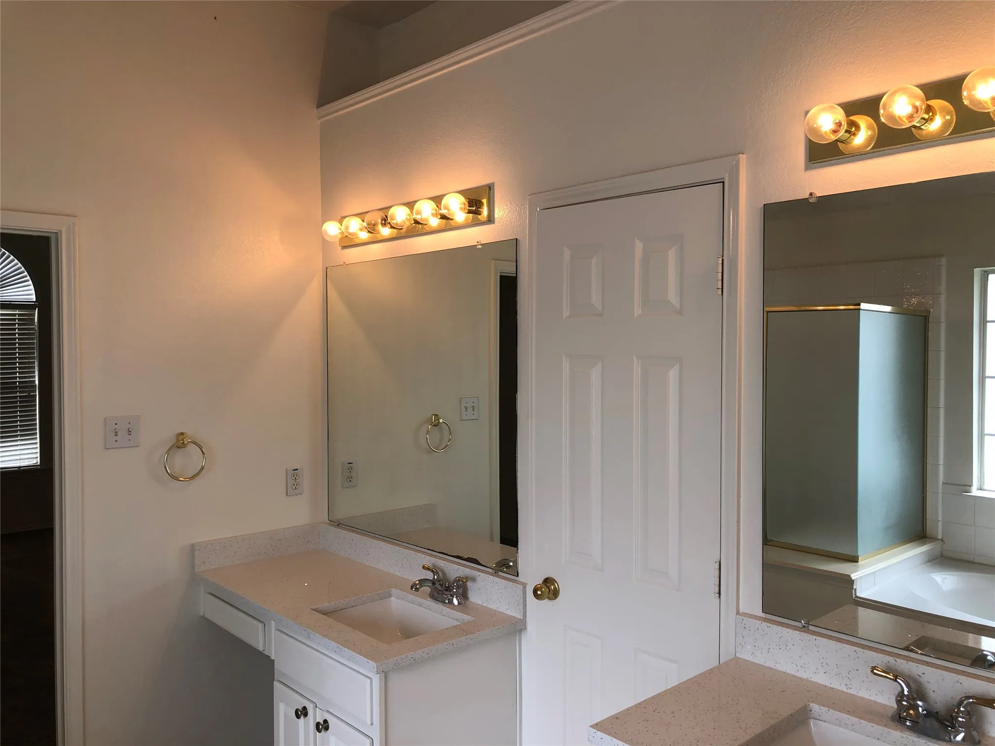 Dual vanity with integrated sinks, light-toned countertops, and built-in medicine cabinets
