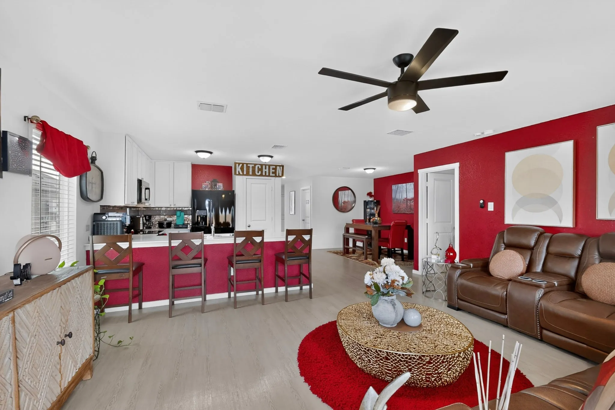 Open-concept living space featuring wood-finish flooring, a contemporary ceiling fan, and recessed lighting