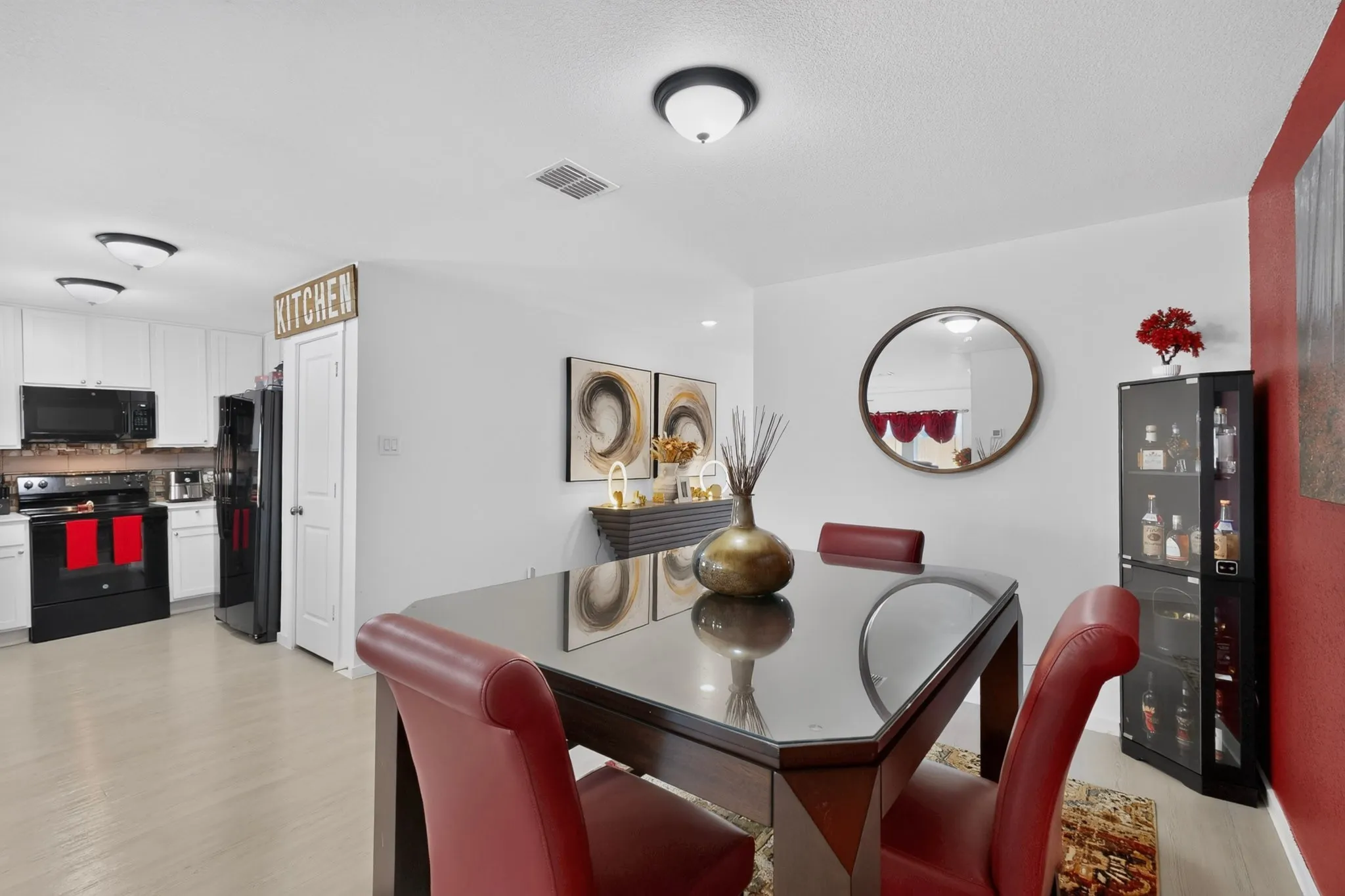 Kitchen featuring white cabinetry and black appliances