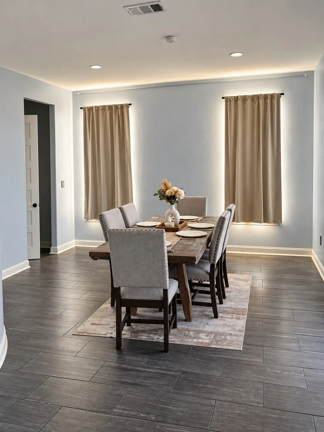 Recessed ceiling lighting, crown molding with accent lighting, dark wood-finish flooring, and white trim