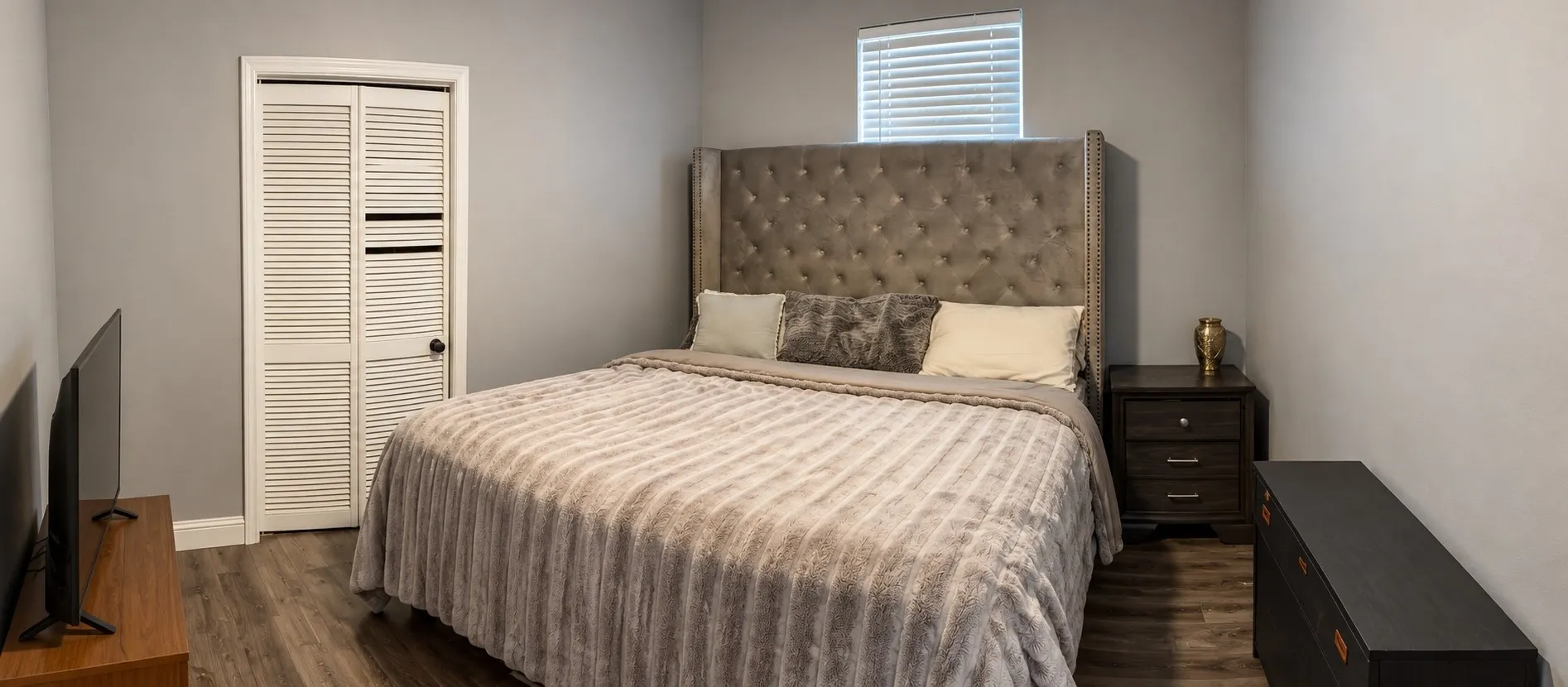 Neutral-toned walls complement wood-finish flooring