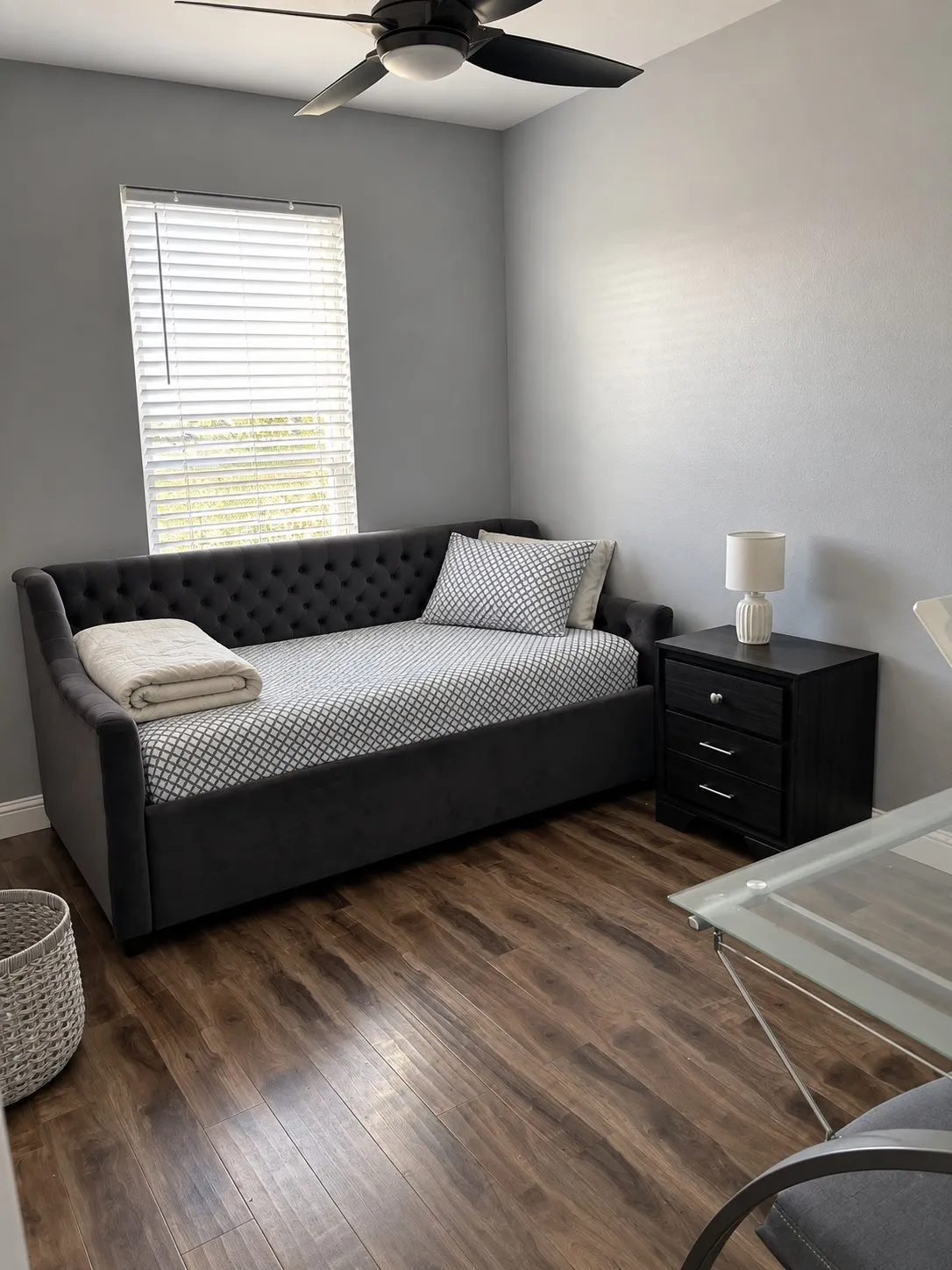 Wood-finish flooring throughout, complemented by a ceiling fan with integrated lighting