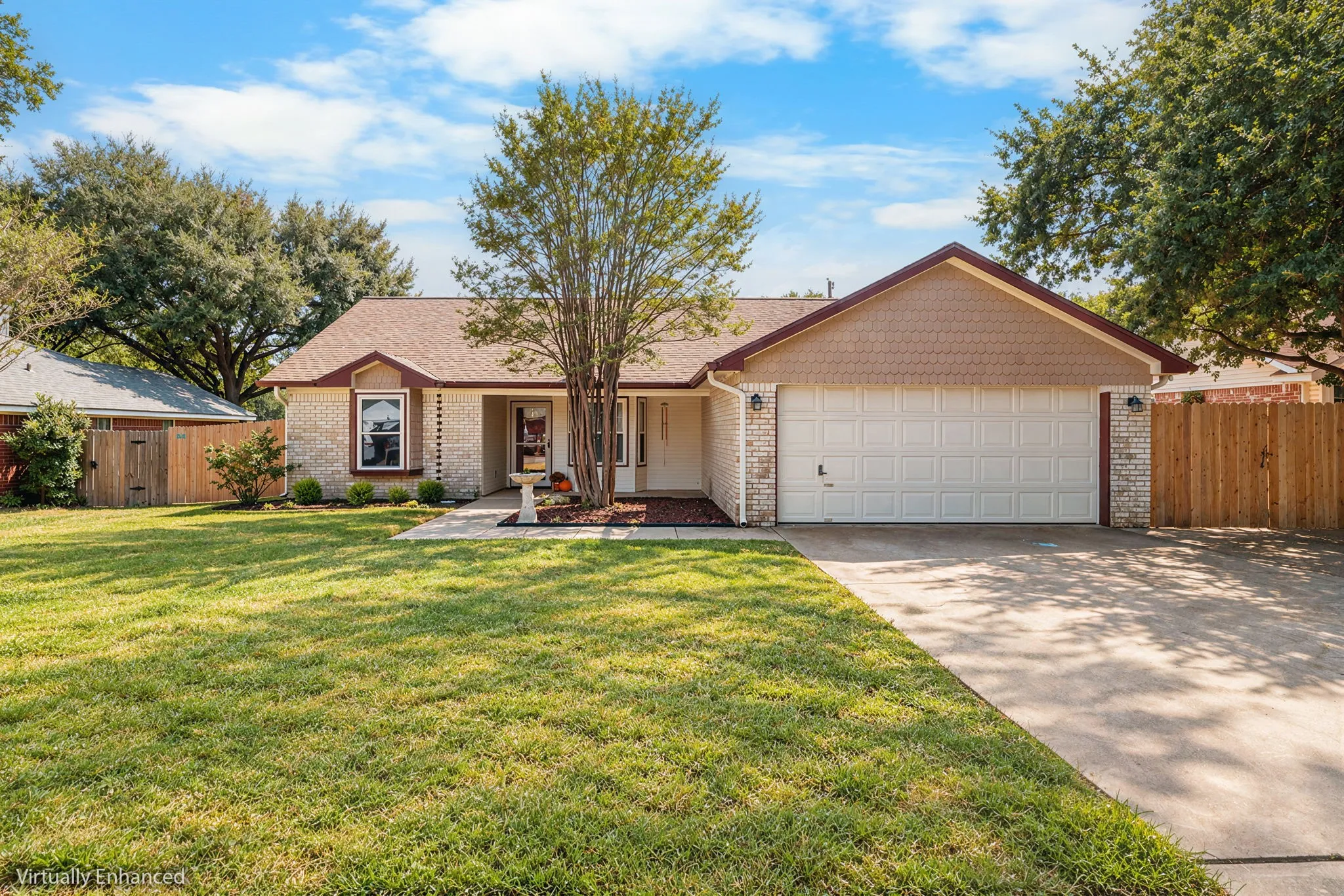 Brick exterior with a shingle roof and a two-car garage
