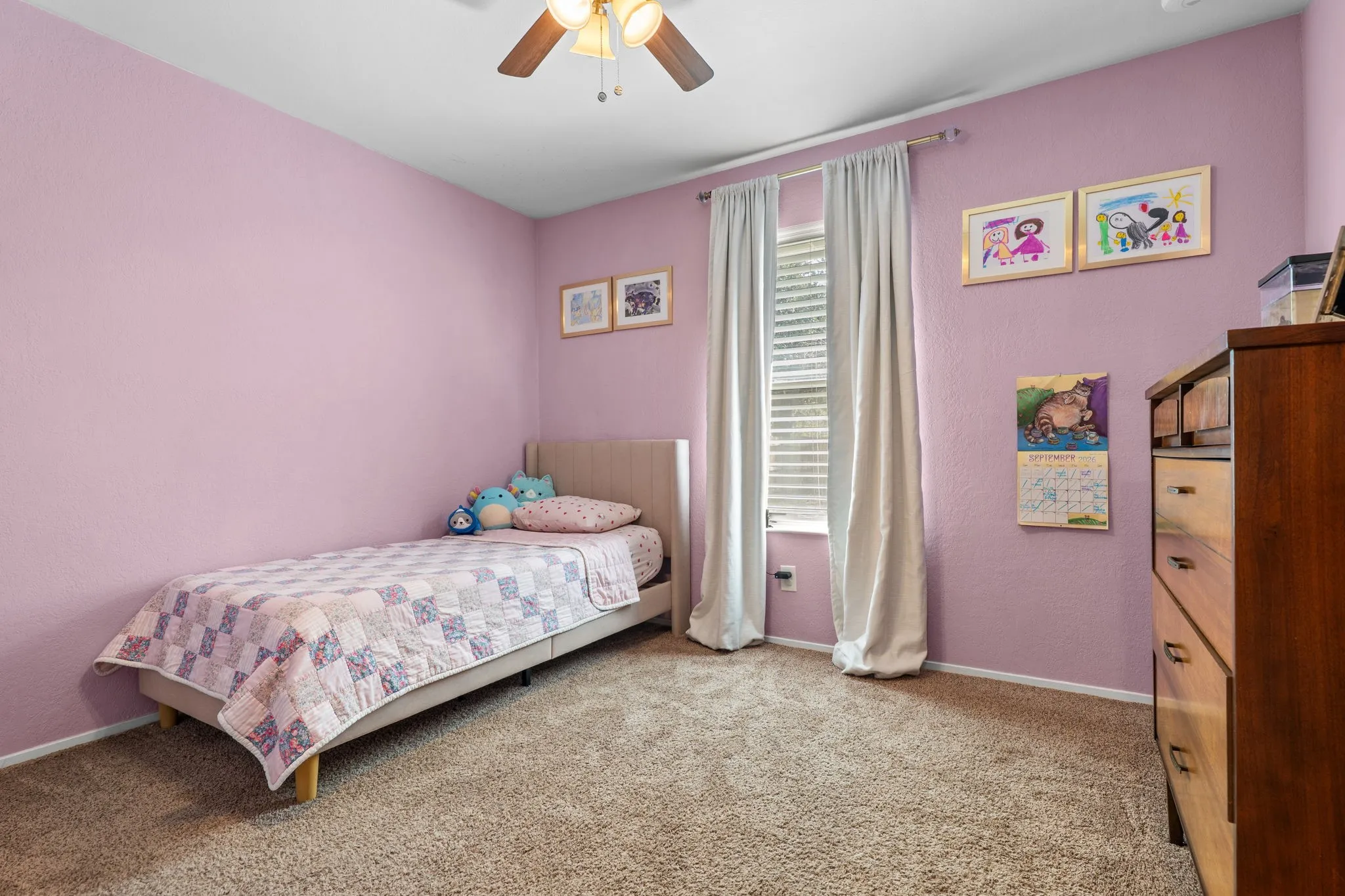 Wall-to-wall carpeting, ceiling fan with integrated lighting, and window with blinds and drapes