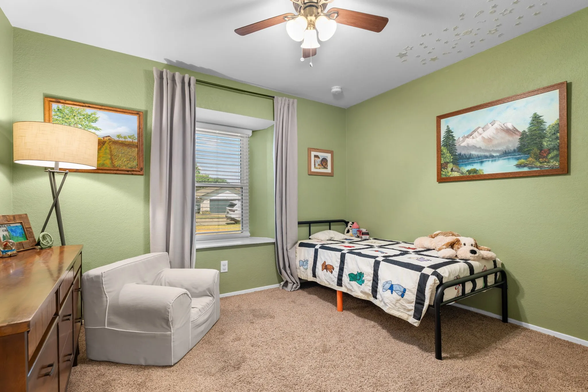 Carpeted room featuring a ceiling fan, window with blinds, and light green walls
