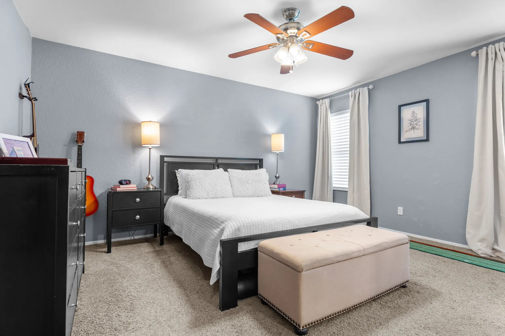 Ceiling fan with integrated lighting, textured wall finish, and window with blinds
