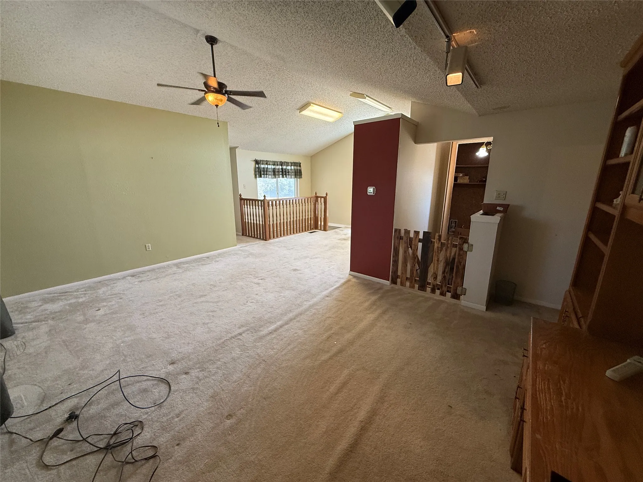 Vaulted ceiling with a ceiling fan and recessed lighting