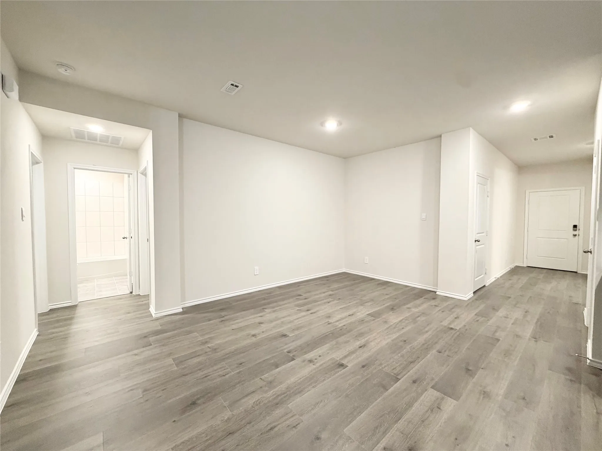 Dining area and hallway to 2nd bedroom, 3rd bedroom and 2nd full bathroom
