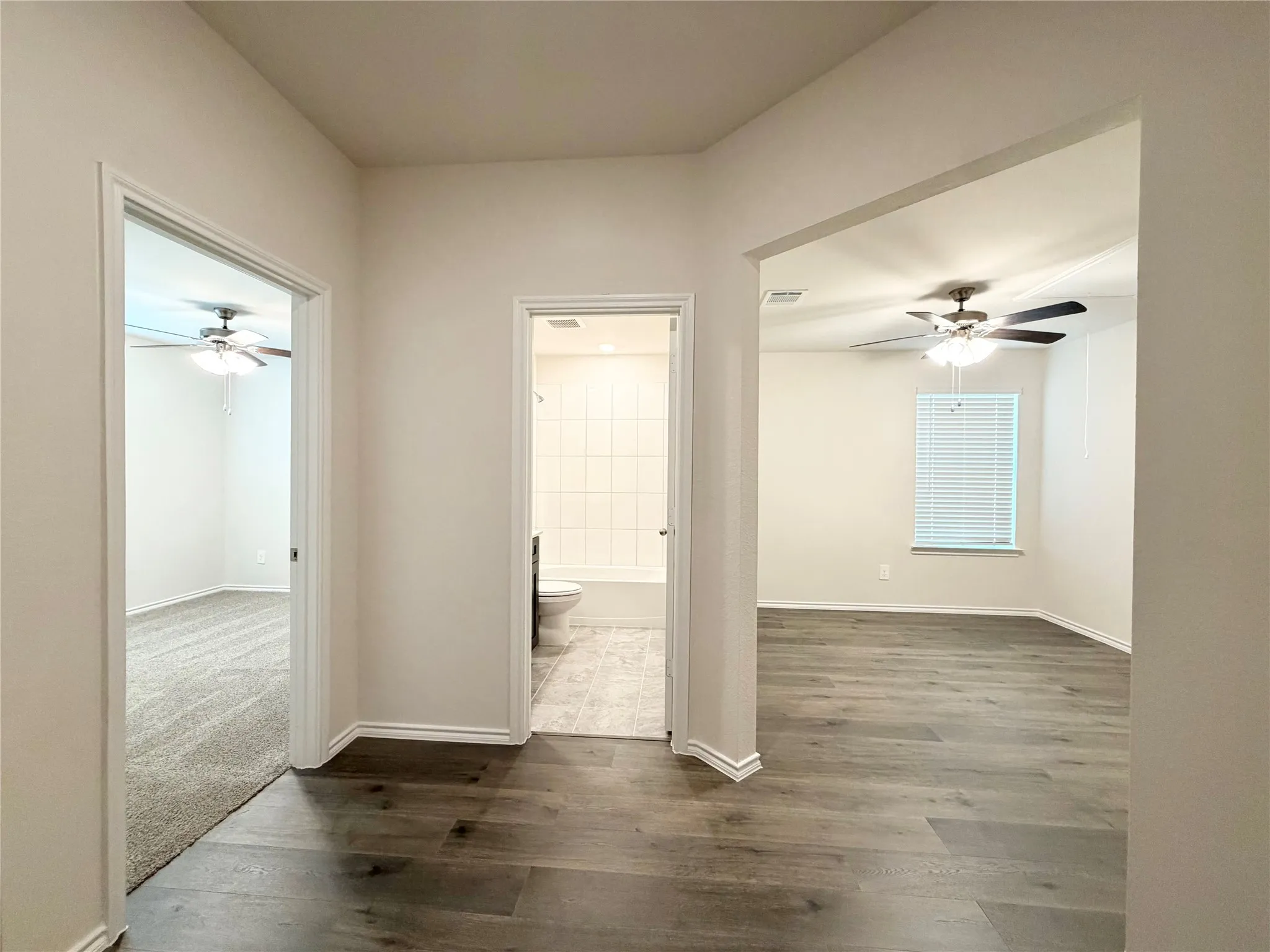 Corridor to 1st bedroom, full bathroom and bonus room