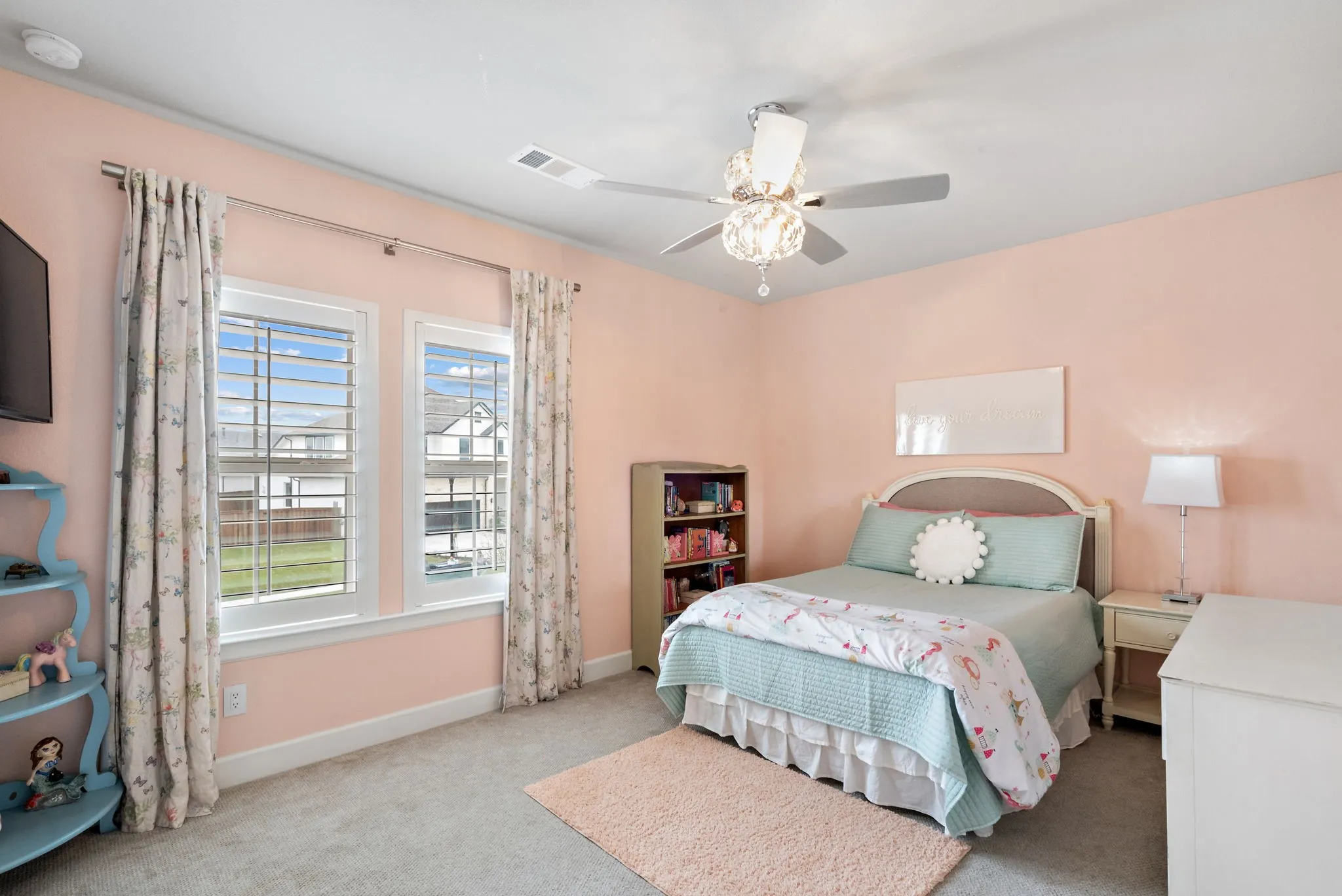 Recessed lighting, ceiling fan with light fixture, two windows with blinds, built-in shelving, and carpeting