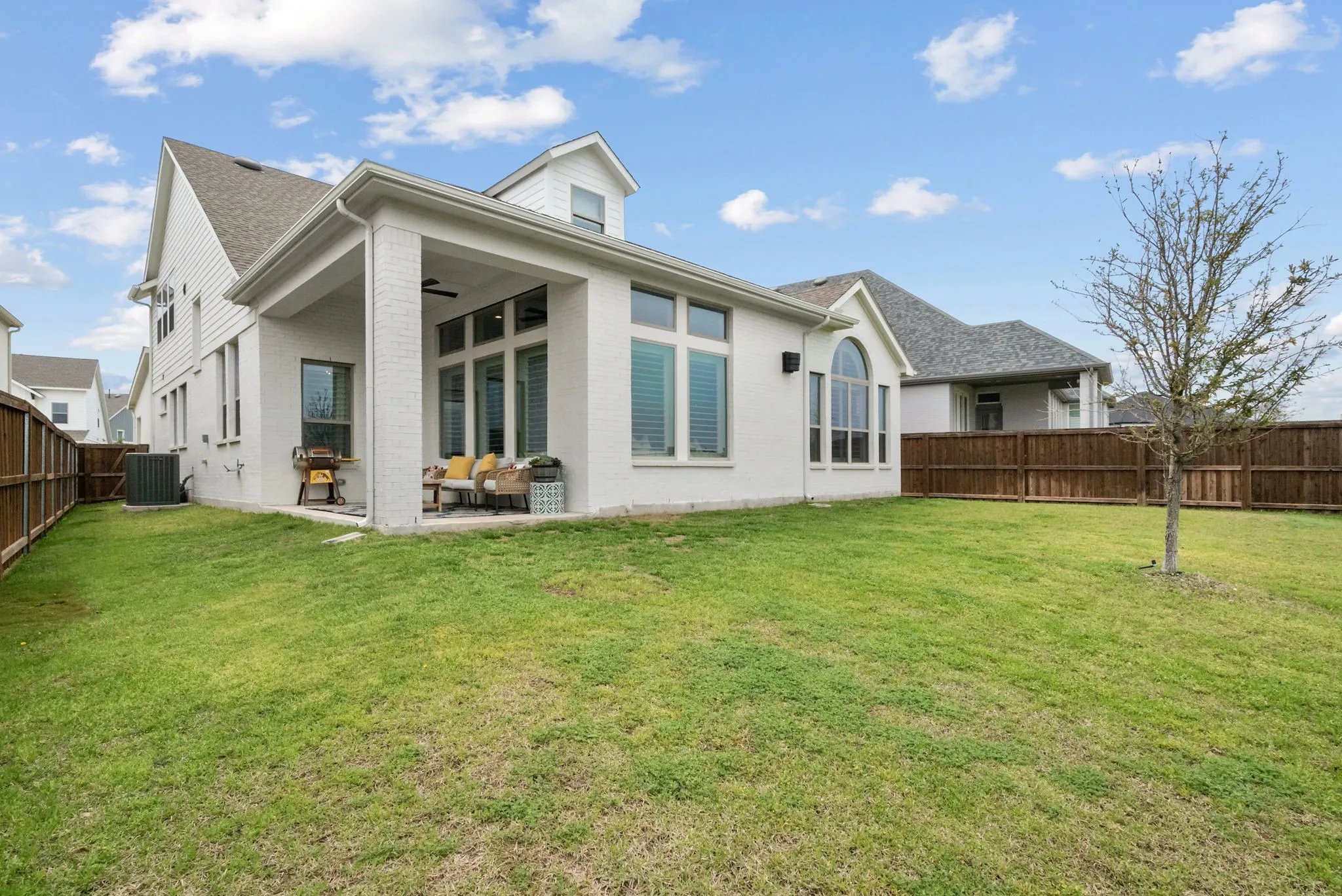 Expansive grass lawn with a full privacy fence