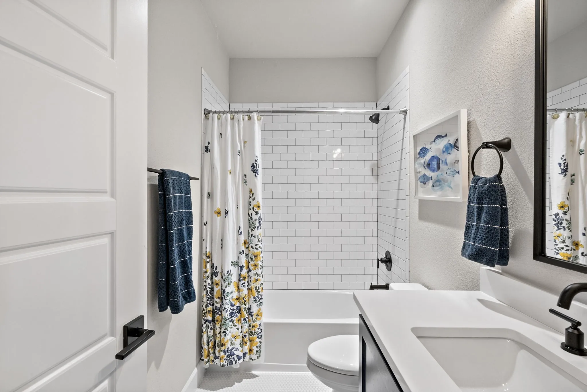 White subway tile shower surround with a fixed glass panel