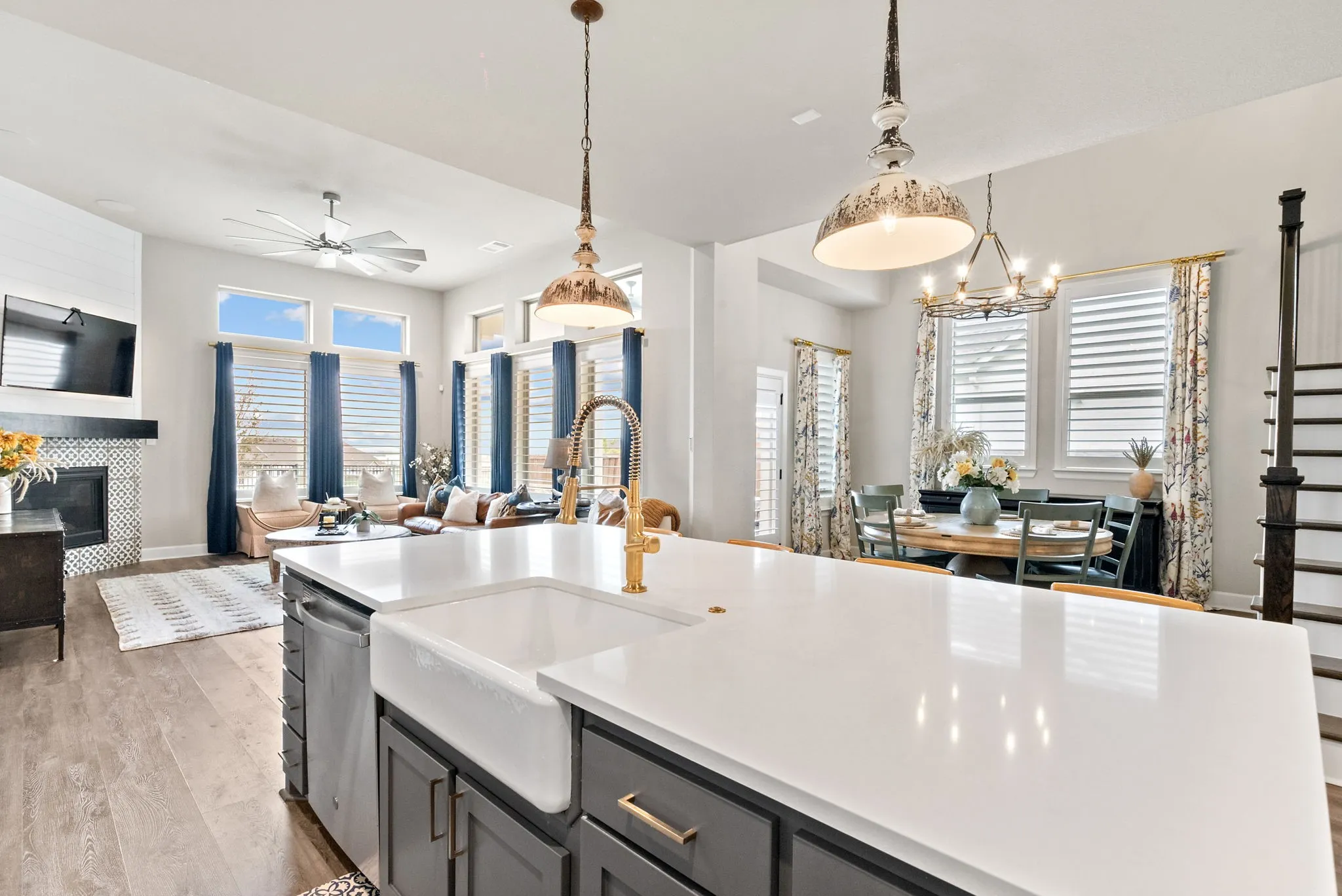 Spacious kitchen island with white countertop and farmhouse sink