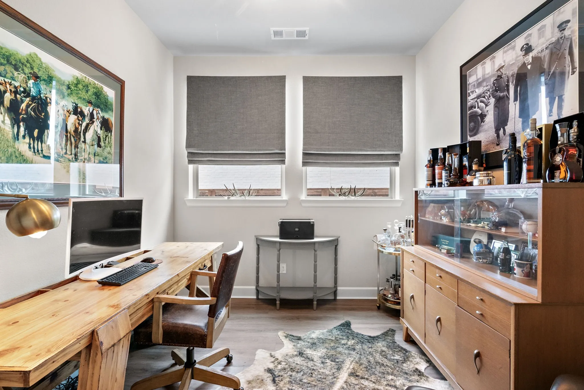 Recessed lighting, wood-finish flooring, two windows with window treatments, and white wall finishes