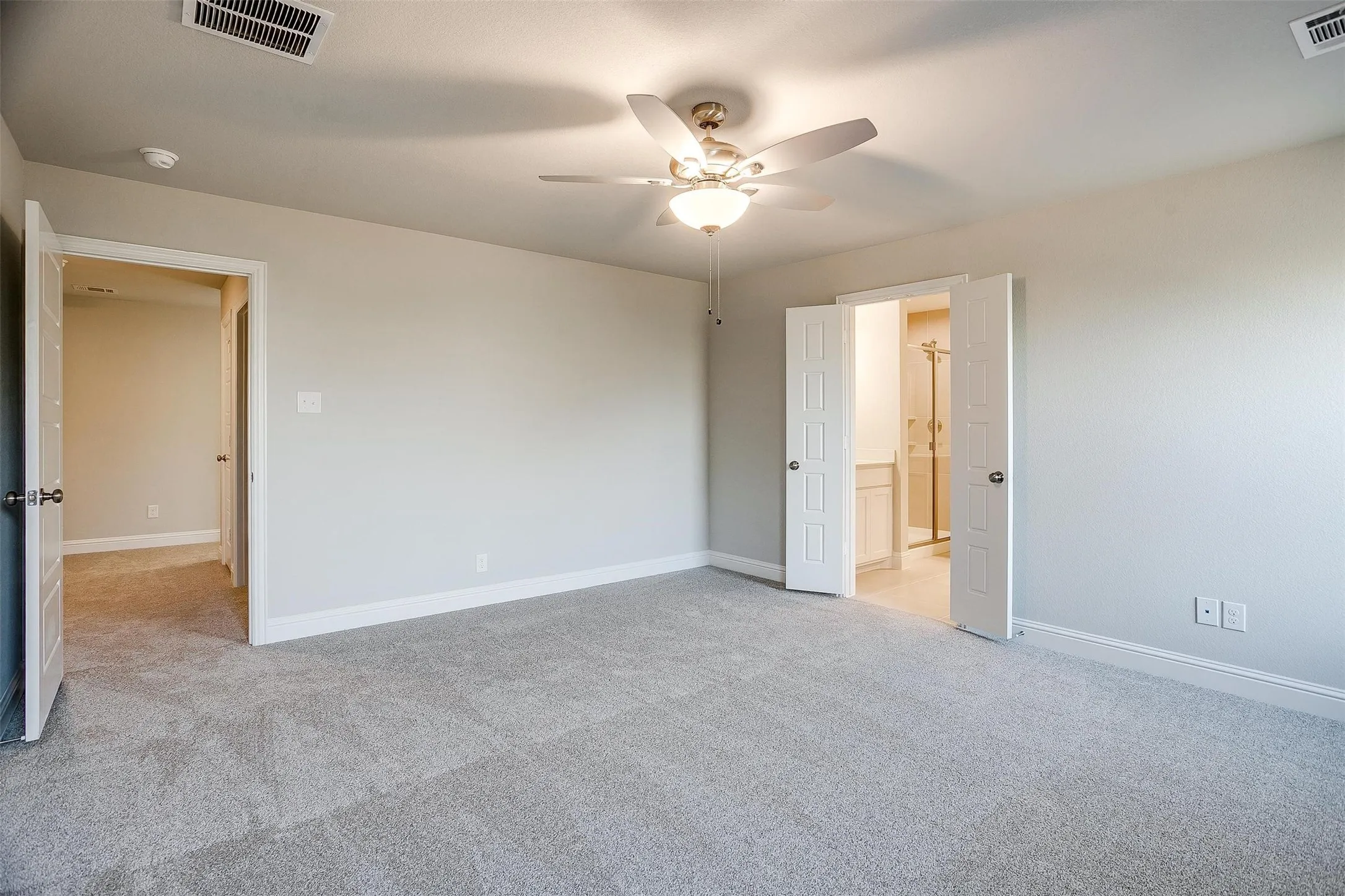 Neutral-toned walls complement the gray carpeting