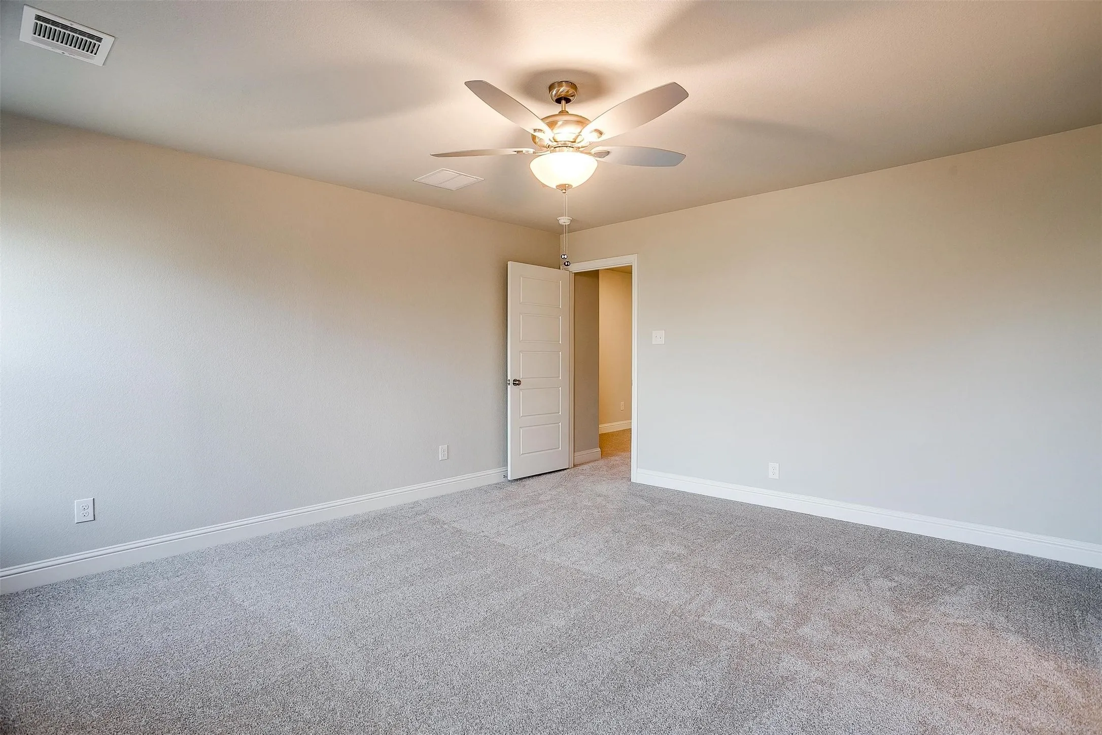 Neutral-toned walls, ceiling fan, carpeted flooring, and white trim