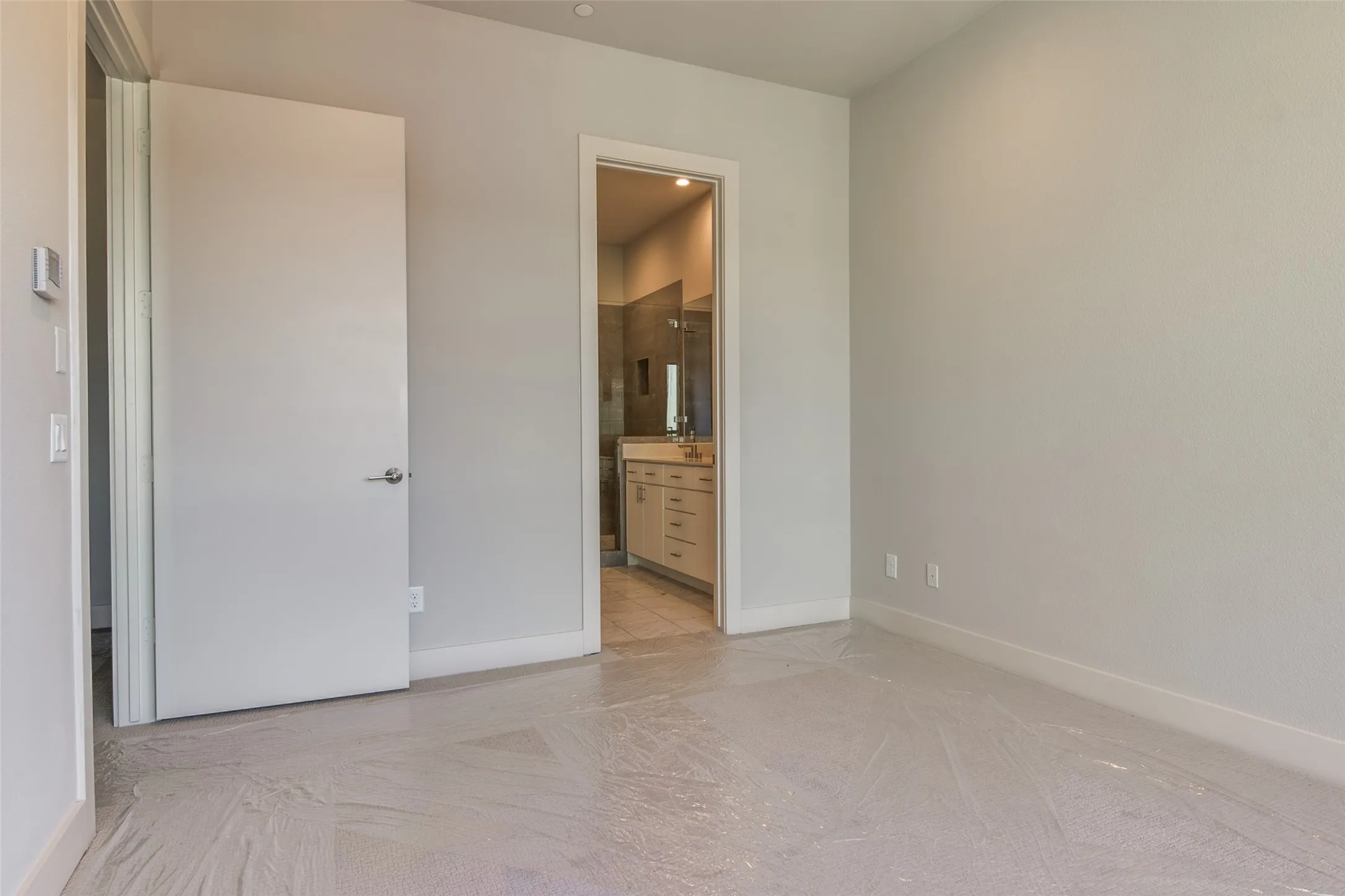 Bedroom on first floor with ensuite bath and concrete floors