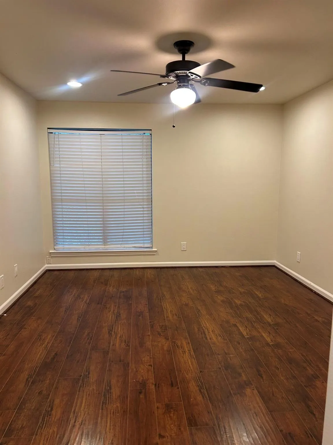 Wood-finish flooring, recessed lighting, ceiling fan with integrated light, neutral wall tones, and window blinds