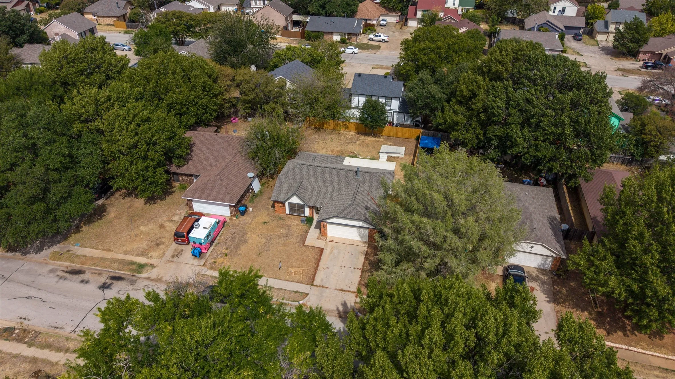 Single-story residence with an attached garage, featuring a shingle roof and a concrete driveway