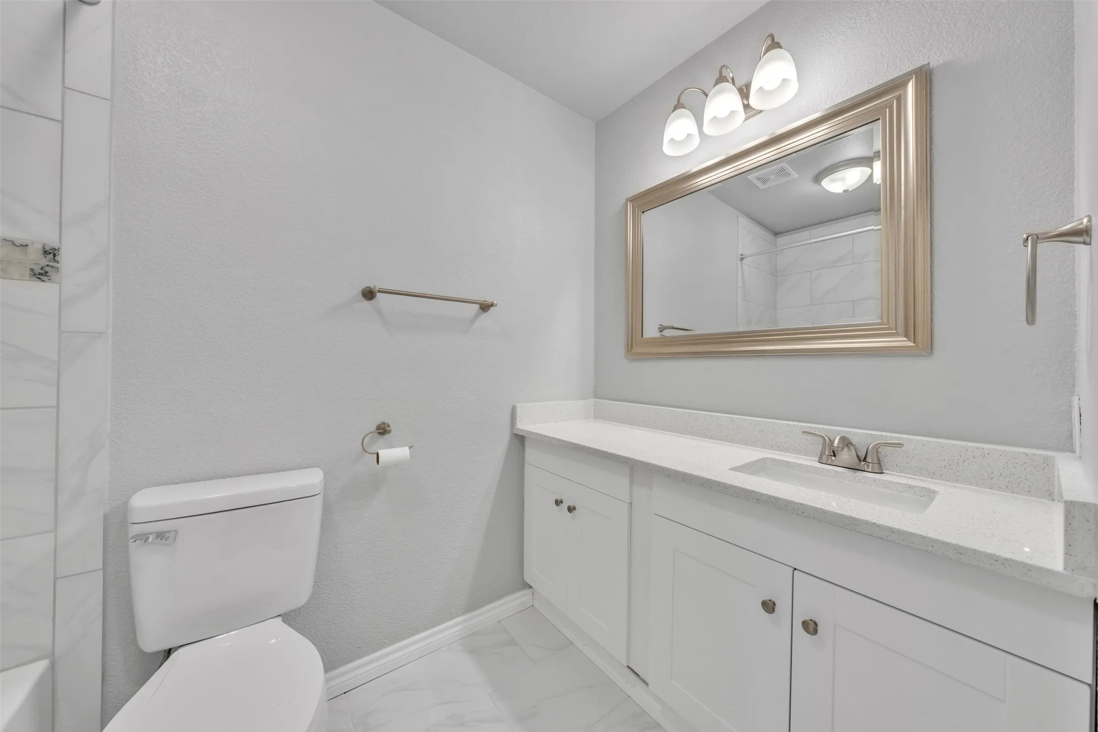 White vanity with a single integrated sink and silver-finish faucet