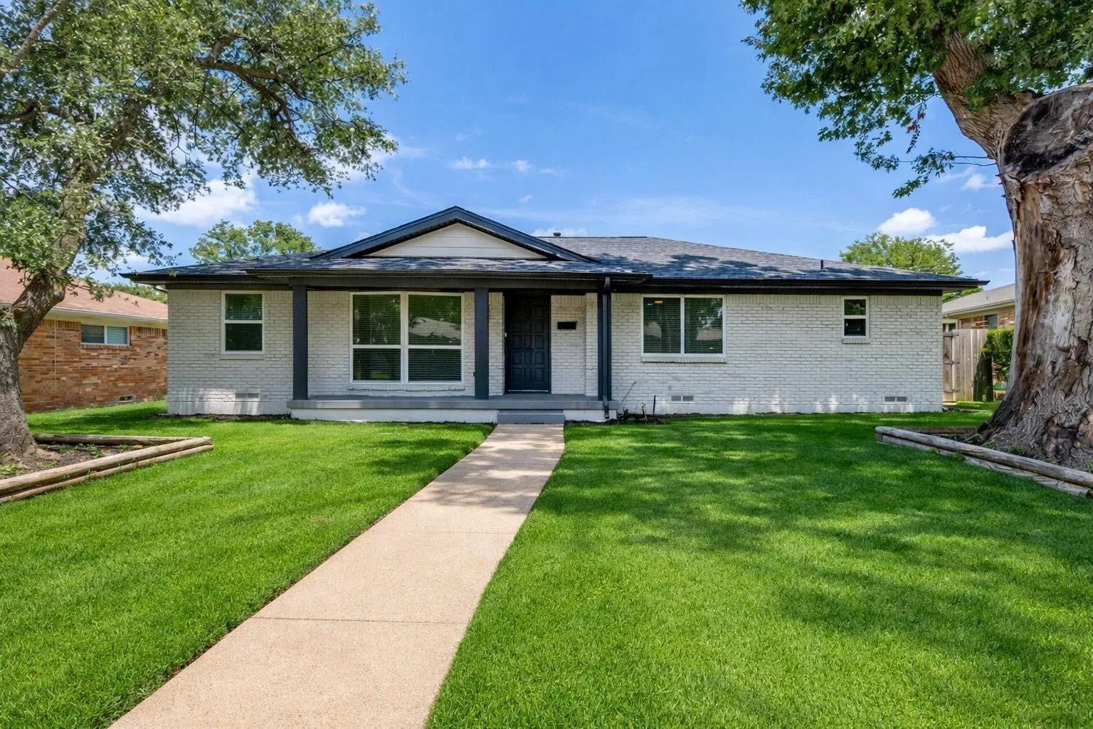 White brick exterior with dark trim accents